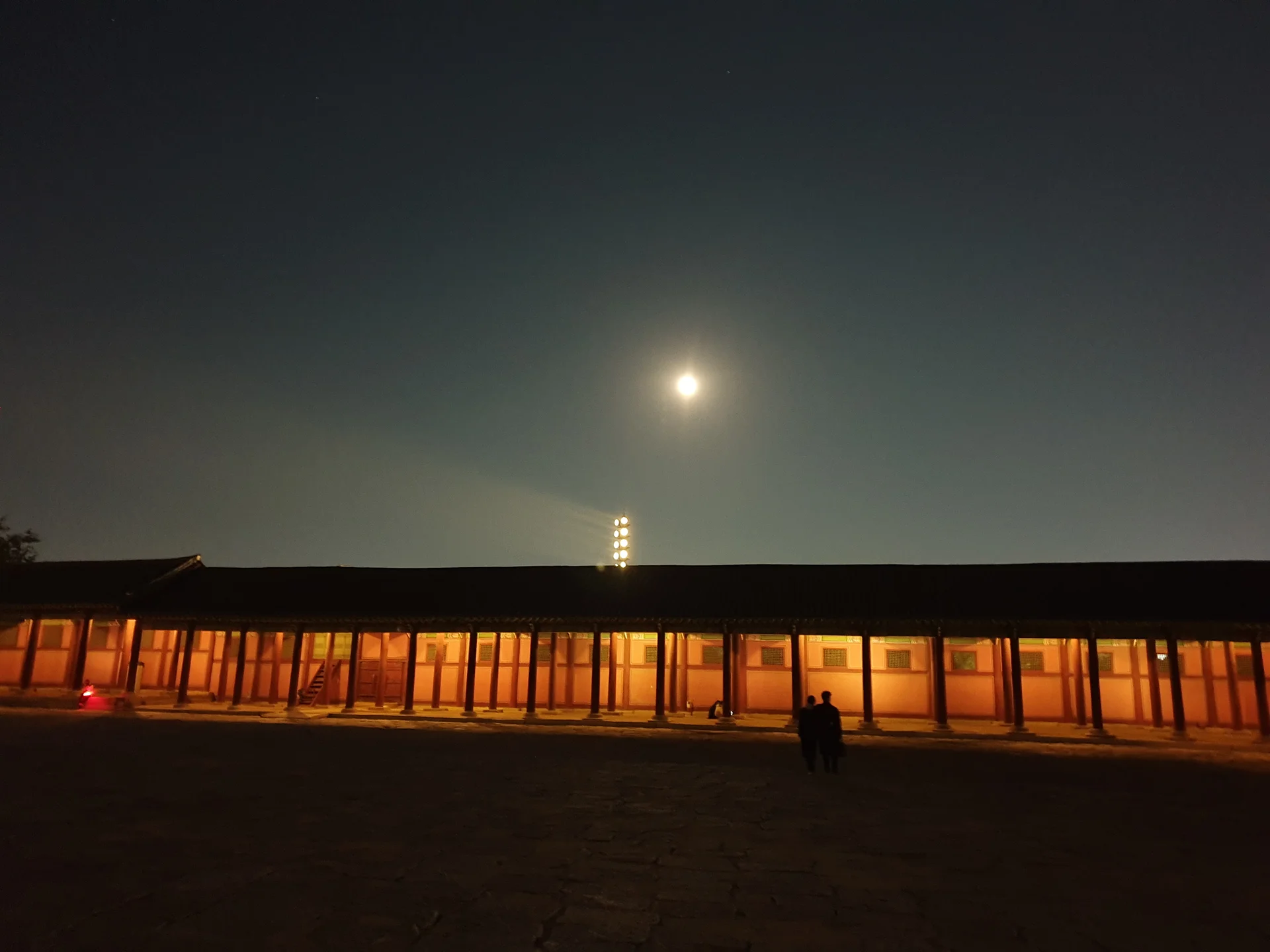 Light up your phone with the electric energy of Seoul after dark. These Korean nightscape wallpapers capture the city at its most cinematic — neon signage stacking up narrow alleyways, glowing street food stalls sending steam into cold night air, illuminated bridges spanning the Han River, and the shimmering towers of Gangnam reflected in rain-wet streets.

Seoul's nighttime personality is bold, colorful, and endlessly photogenic. You'll find the moody glow of Itaewon bars, the cyberpunk atmosphere of Euljiro's industrial blocks, and panoramic cityscapes from hilltop viewpoints where the city stretches to the horizon in every direction. Free download these aesthetic Seoul night wallpapers for a phone background that pulses with urban energy., Seoul, Gyeongbokgung Palace — Free Korean aesthetic wallpaper