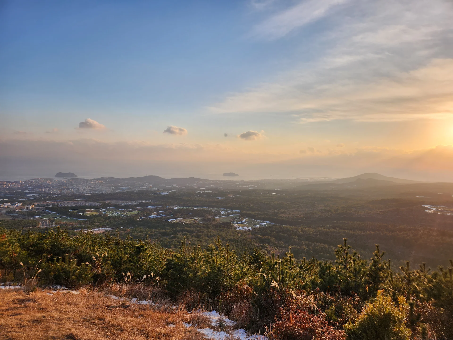 Set your phone against the majestic backdrop of Korea's mountain ranges. The Korean peninsula is nearly 70% mountainous, and these wallpapers celebrate that dramatic terrain — jagged granite peaks rising above the clouds, ancient fortress walls tracing ridgelines, and forest trails disappearing into autumn-colored valleys.

From the iconic rocky summits of Bukhansan in Seoul to the remote alpine meadows of Seoraksan, each image captures the scale and serenity of Korean mountain landscapes across all four seasons. Snow-dusted winter peaks, spring azalea blooms on hillsides, summer greenery, and fiery fall foliage are all here. Free download these aesthetic mountain wallpapers and carry Korea's highland grandeur in your pocket., Donghong-dong, Seogwipo-si — Free Korean aesthetic wallpaper