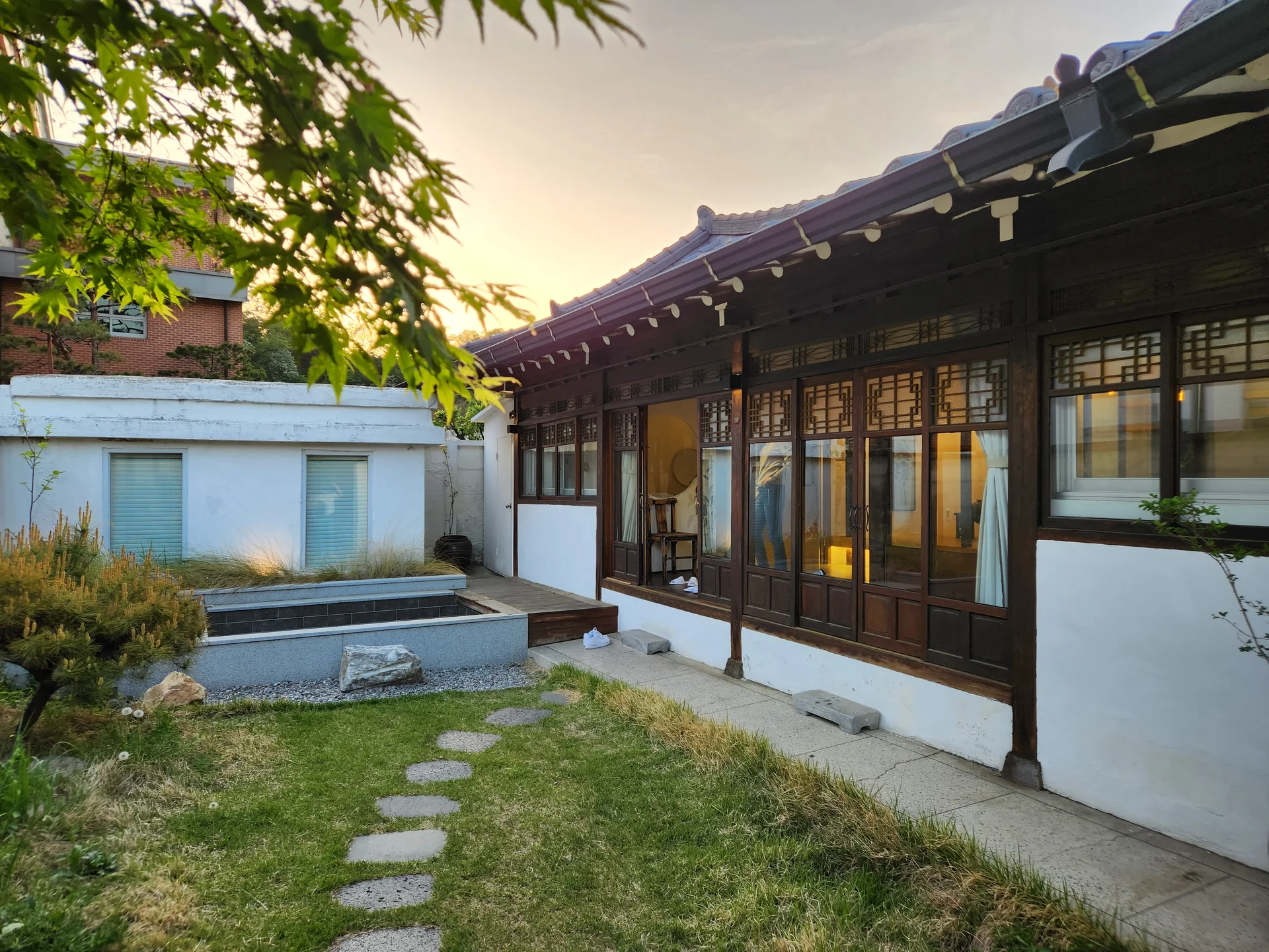 Adorn your phone with the timeless elegance of hanok, Korea's traditional wooden houses. These wallpapers showcase the graceful curved rooflines, hand-carved wooden lattice doors, and serene inner courtyards that have defined Korean residential architecture for centuries. Preserved hanok villages in Bukchon and Jeonju offer a living window into Korea's past.

Each image reveals the quiet beauty of these heritage homes — clay walls weathered to warm earth tones, dark timber frames contrasting with paper-screened windows, stone foundations meeting manicured courtyard gardens, and traditional eaves silhouetted against modern skylines. Download these free hanok wallpapers for an aesthetic phone background that celebrates the harmony between Korean tradition and contemporary life., Seohak 3-gil, Jeon-dong, Jeonju-si — Free Korean aesthetic wallpaper