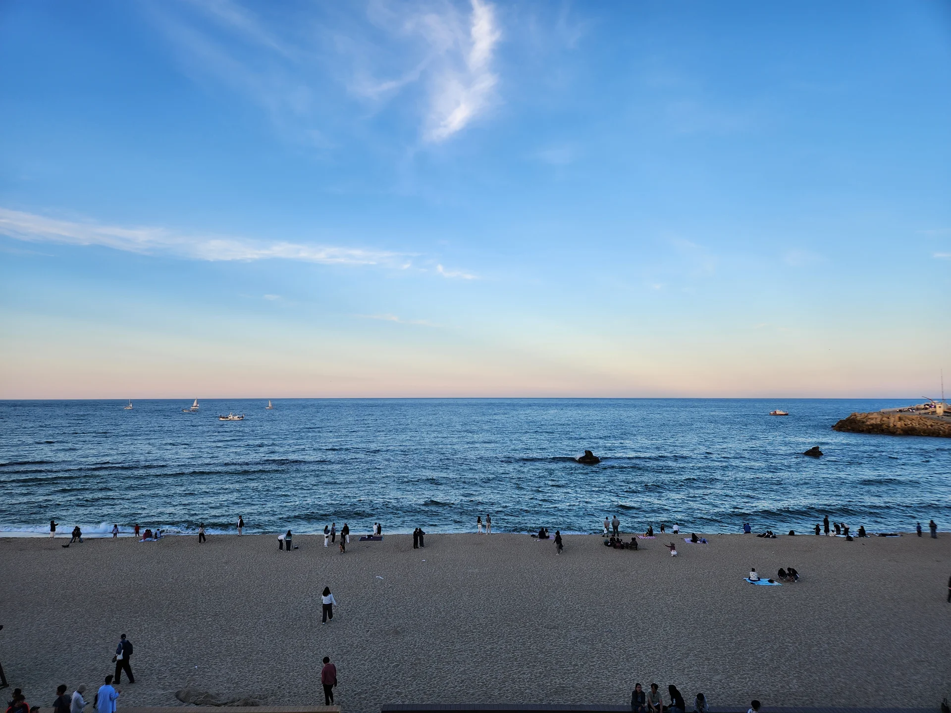 Bring the Korean coastline to your phone with these breathtaking ocean wallpapers. Korea is surrounded by water on three sides, and this collection captures it all — the turquoise shallows of Jeju's beaches, dramatic basalt cliffs plunging into the East Sea, tranquil fishing harbors at dawn, and endless Pacific horizons glowing under golden light.

These photos feature crashing waves against volcanic rock formations, serene island silhouettes at sunset, lighthouse beacons cutting through coastal fog, and the mirror-still surface of sheltered bays reflecting cotton-candy skies. Download these free Korean sea wallpapers for an aesthetic phone background that carries the calm and power of the ocean wherever you go., Changhae-ro 14beon-gil, 송정동, Gangneung-si — Free Korean aesthetic wallpaper