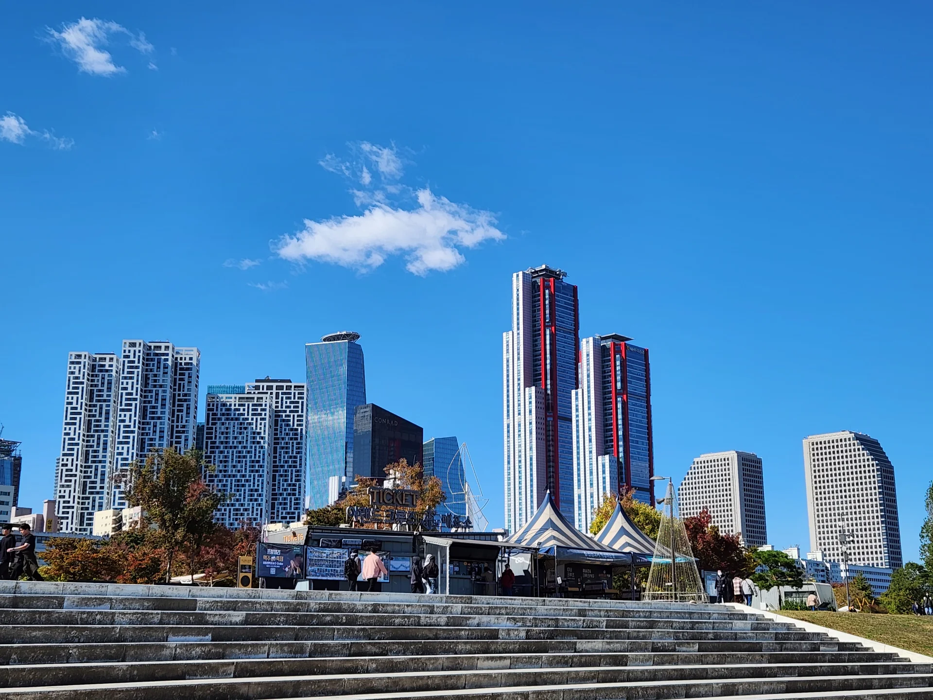 Explore Korea's architectural landscape through stunning phone wallpapers that span centuries of design. From the sleek glass curtain walls of Gangnam's skyscrapers to the raw concrete forms of brutalist apartment complexes, these images capture how Korea blends cutting-edge modernity with bold structural expression.

Look closer and you'll discover geometric patterns in subway station ceilings, sweeping curves of the Dongdaemun Design Plaza, and the quiet symmetry of traditional gate structures standing beside high-rises. Whether you're drawn to minimalist Korean design or dramatic urban geometry, these free aesthetic wallpapers transform your phone background into a gallery of architectural photography., Yeoui-dong, Seoul — Free Korean aesthetic wallpaper