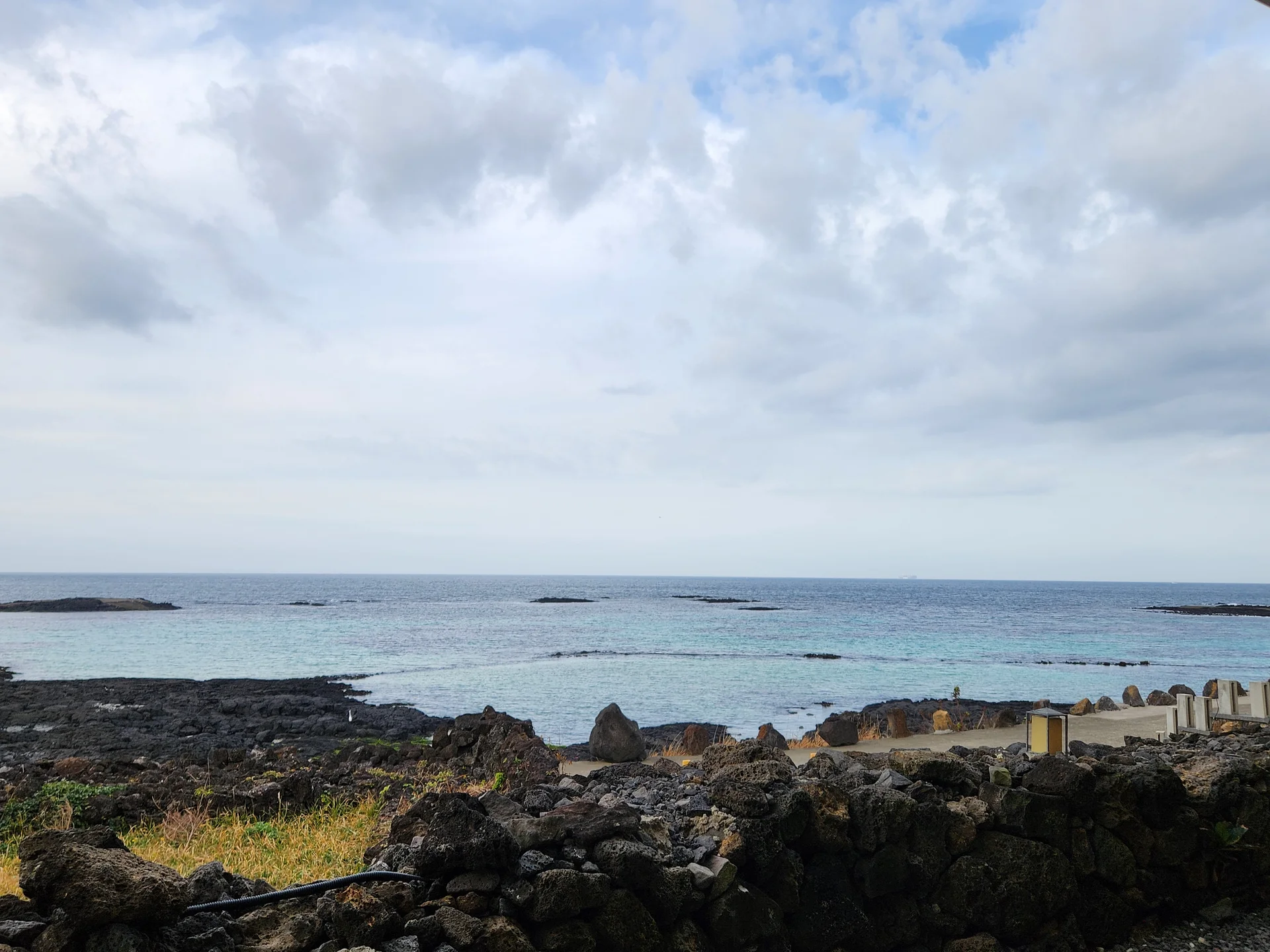 Bring the Korean coastline to your phone with these breathtaking ocean wallpapers. Korea is surrounded by water on three sides, and this collection captures it all — the turquoise shallows of Jeju's beaches, dramatic basalt cliffs plunging into the East Sea, tranquil fishing harbors at dawn, and endless Pacific horizons glowing under golden light.

These photos feature crashing waves against volcanic rock formations, serene island silhouettes at sunset, lighthouse beacons cutting through coastal fog, and the mirror-still surface of sheltered bays reflecting cotton-candy skies. Download these free Korean sea wallpapers for an aesthetic phone background that carries the calm and power of the ocean wherever you go., 해맞이해안로, Jeju — Free Korean aesthetic wallpaper