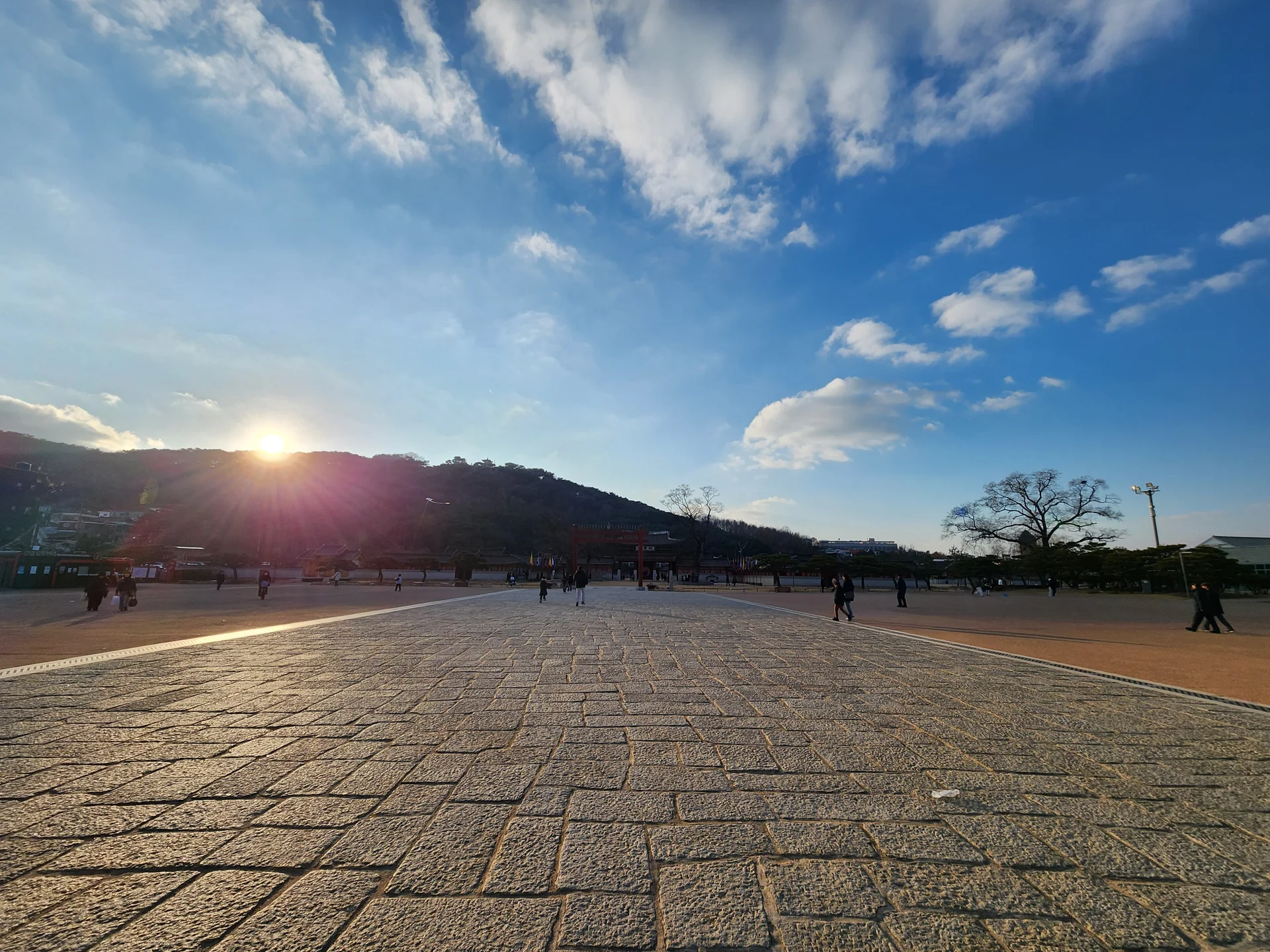 Explore Korea's architectural landscape through stunning phone wallpapers that span centuries of design. From the sleek glass curtain walls of Gangnam's skyscrapers to the raw concrete forms of brutalist apartment complexes, these images capture how Korea blends cutting-edge modernity with bold structural expression.

Look closer and you'll discover geometric patterns in subway station ceilings, sweeping curves of the Dongdaemun Design Plaza, and the quiet symmetry of traditional gate structures standing beside high-rises. Whether you're drawn to minimalist Korean design or dramatic urban geometry, these free aesthetic wallpapers transform your phone background into a gallery of architectural photography., Hwaseong Haenggung Square, Paldallo 1-ga, 팔달구, Suwon-si — Free Korean aesthetic wallpaper