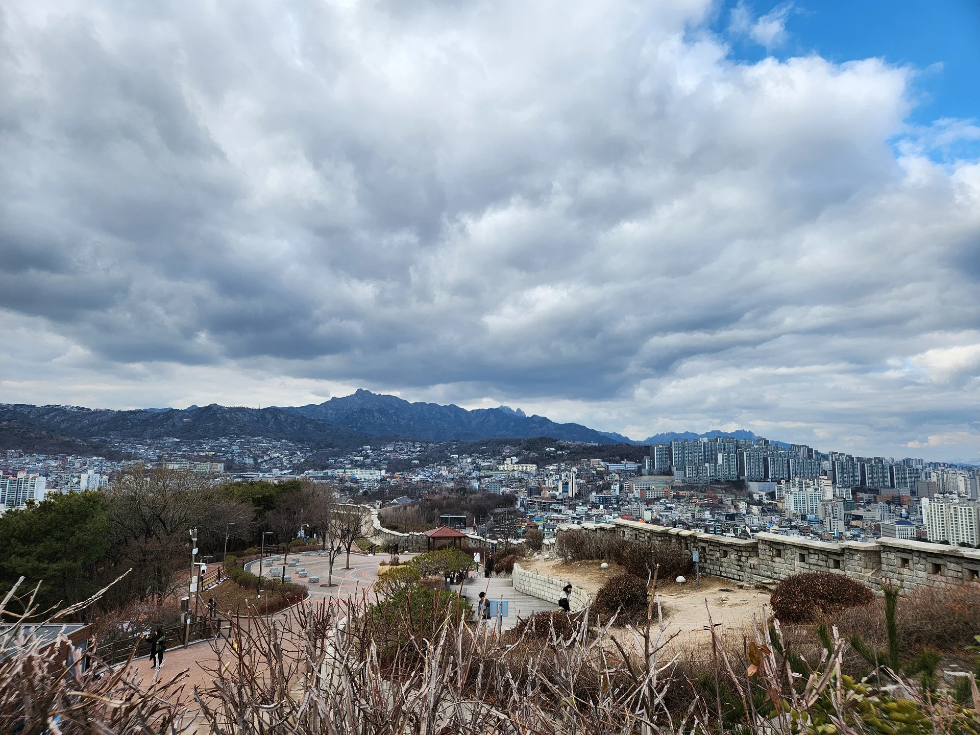 Immerse your screen in the untouched beauty of Korea's natural world. These Korean wallpapers feature sweeping countryside fields blanketed in green, hidden valleys where morning mist clings to the hillsides, and winding streams cutting through rocky terrain. Each photo captures the raw, peaceful energy that makes Korea's landscapes so distinctive.

From the volcanic plains of Jeju Island to the lush wetlands of Suncheon Bay, this collection showcases nature in every mood — dramatic storm clouds rolling over ridgelines, golden sunlight filtering through canopy gaps, and wildflower meadows stretching toward distant peaks. Download these aesthetic phone backgrounds for free and bring a moment of Korean tranquility to your daily life., Naksan-gil, Ihwa-dong, Seoul — Free Korean aesthetic wallpaper