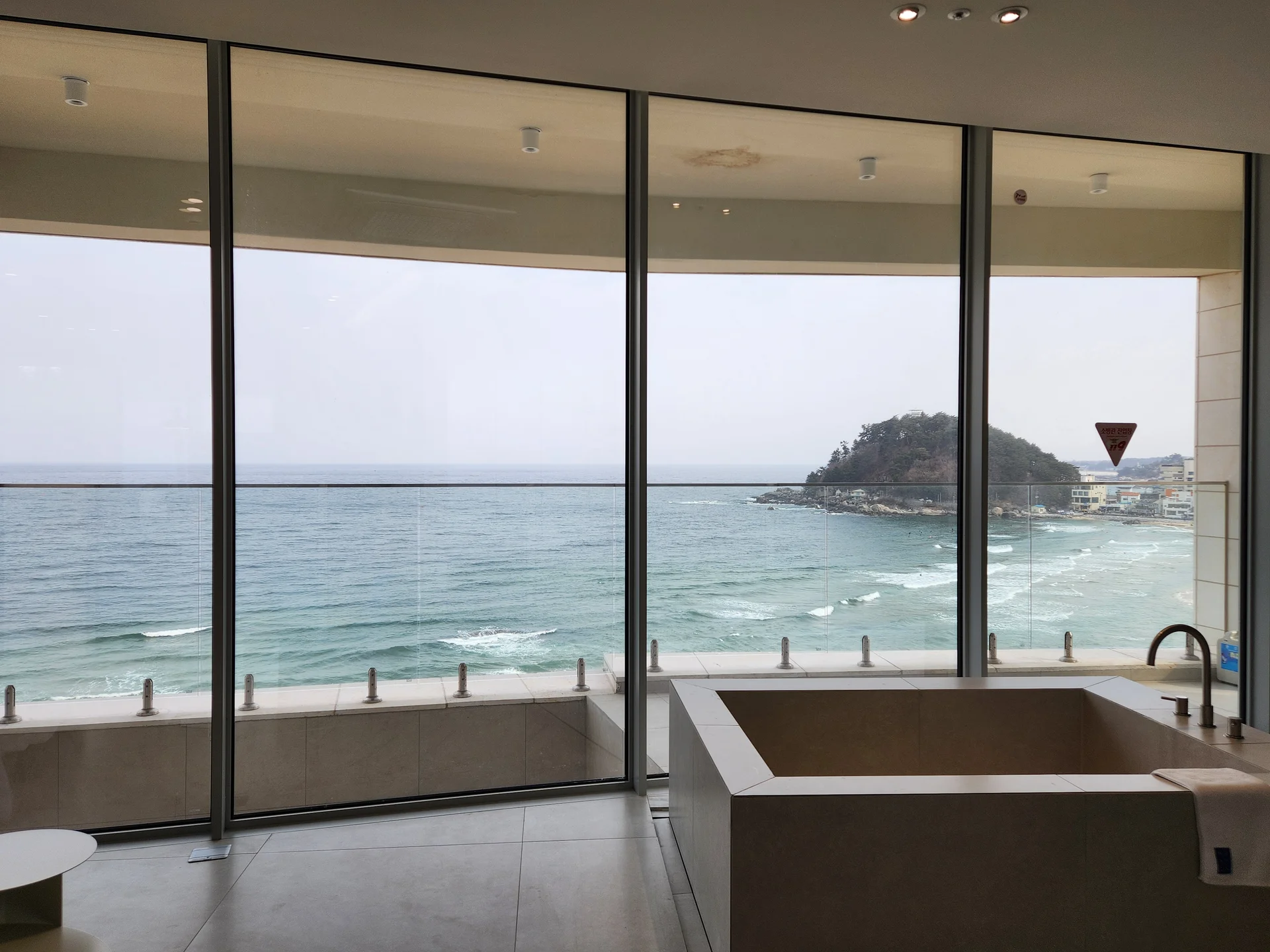 Wrap your phone in the cozy, Instagram-worthy atmosphere of Korean cafe culture. Korea's cafes are more than coffee shops — they're design experiences. These wallpapers feature warm interior light falling on minimalist wooden counters, perfectly crafted latte art in handmade ceramic cups, floor-to-ceiling windows overlooking quiet streets, and rooftop terraces with city panoramas.

From industrial-chic converted warehouses in Seongsu to tiny hidden basement cafes in Ikseon-dong, each image captures the aesthetic sensibility that makes Korean cafe design world-famous. Trailing plants, warm Edison bulbs, curated book walls, and the soft golden glow of afternoon light create scenes you'll want to stare at. Download these free Korean cafe wallpapers for a phone background that feels like a warm hug., Dongsankeun-gil, Hyeonnam — Free Korean aesthetic wallpaper