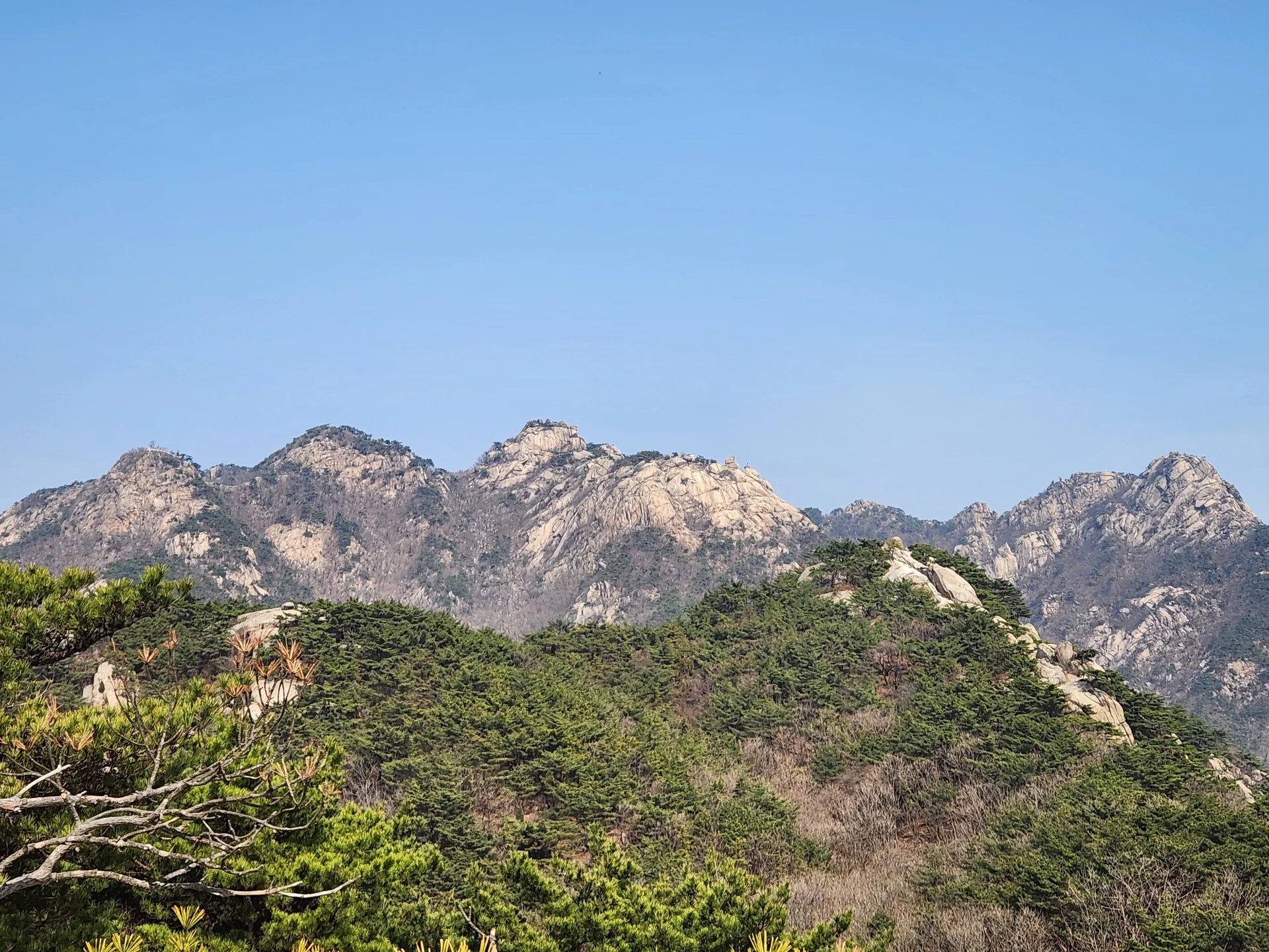 Set your phone against the majestic backdrop of Korea's mountain ranges. The Korean peninsula is nearly 70% mountainous, and these wallpapers celebrate that dramatic terrain — jagged granite peaks rising above the clouds, ancient fortress walls tracing ridgelines, and forest trails disappearing into autumn-colored valleys.

From the iconic rocky summits of Bukhansan in Seoul to the remote alpine meadows of Seoraksan, each image captures the scale and serenity of Korean mountain landscapes across all four seasons. Snow-dusted winter peaks, spring azalea blooms on hillsides, summer greenery, and fiery fall foliage are all here. Free download these aesthetic mountain wallpapers and carry Korea's highland grandeur in your pocket., Samobawi, Pyeongchang-dong, Seoul — Free Korean aesthetic wallpaper
