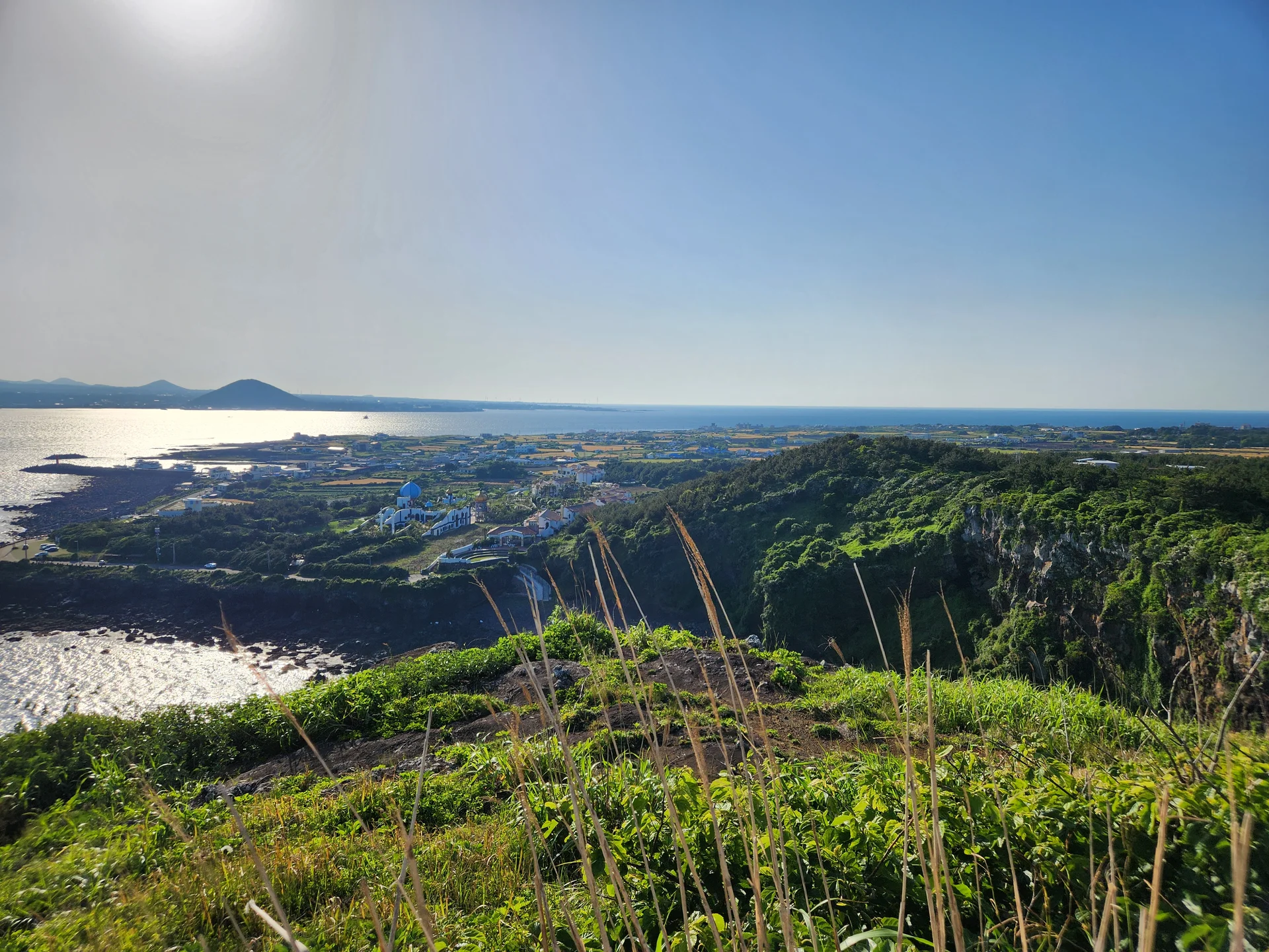 Immerse your screen in the untouched beauty of Korea's natural world. These Korean wallpapers feature sweeping countryside fields blanketed in green, hidden valleys where morning mist clings to the hillsides, and winding streams cutting through rocky terrain. Each photo captures the raw, peaceful energy that makes Korea's landscapes so distinctive.

From the volcanic plains of Jeju Island to the lush wetlands of Suncheon Bay, this collection showcases nature in every mood — dramatic storm clouds rolling over ridgelines, golden sunlight filtering through canopy gaps, and wildflower meadows stretching toward distant peaks. Download these aesthetic phone backgrounds for free and bring a moment of Korean tranquility to your daily life., Yeonpyeong-ri, Jeju — Free Korean aesthetic wallpaper