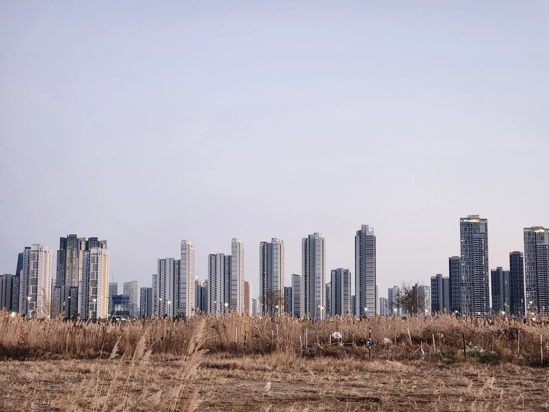 Explore Korea's architectural landscape through stunning phone wallpapers that span centuries of design. From the sleek glass curtain walls of Gangnam's skyscrapers to the raw concrete forms of brutalist apartment complexes, these images capture how Korea blends cutting-edge modernity with bold structural expression.

Look closer and you'll discover geometric patterns in subway station ceilings, sweeping curves of the Dongdaemun Design Plaza, and the quiet symmetry of traditional gate structures standing beside high-rises. Whether you're drawn to minimalist Korean design or dramatic urban geometry, these free aesthetic wallpapers transform your phone background into a gallery of architectural photography., Incheondaegyo Expressway, Songdo 4(sa)-dong, Incheon — Free Korean aesthetic wallpaper