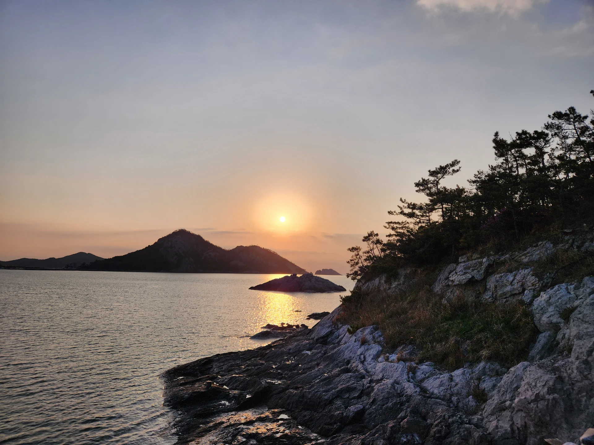 Bring the Korean coastline to your phone with these breathtaking ocean wallpapers. Korea is surrounded by water on three sides, and this collection captures it all — the turquoise shallows of Jeju's beaches, dramatic basalt cliffs plunging into the East Sea, tranquil fishing harbors at dawn, and endless Pacific horizons glowing under golden light.

These photos feature crashing waves against volcanic rock formations, serene island silhouettes at sunset, lighthouse beacons cutting through coastal fog, and the mirror-still surface of sheltered bays reflecting cotton-candy skies. Download these free Korean sea wallpapers for an aesthetic phone background that carries the calm and power of the ocean wherever you go., Seonyudo 1-gil, Gunsan-si — Free Korean aesthetic wallpaper