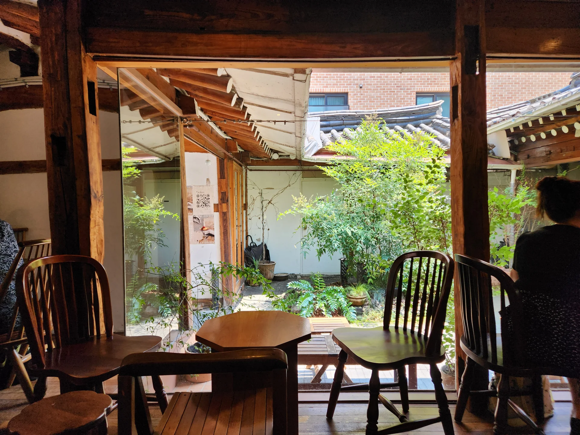 Adorn your phone with the timeless elegance of hanok, Korea's traditional wooden houses. These wallpapers showcase the graceful curved rooflines, hand-carved wooden lattice doors, and serene inner courtyards that have defined Korean residential architecture for centuries. Preserved hanok villages in Bukchon and Jeonju offer a living window into Korea's past.

Each image reveals the quiet beauty of these heritage homes — clay walls weathered to warm earth tones, dark timber frames contrasting with paper-screened windows, stone foundations meeting manicured courtyard gardens, and traditional eaves silhouetted against modern skylines. Download these free hanok wallpapers for an aesthetic phone background that celebrates the harmony between Korean tradition and contemporary life., Seongbuk-ro, Dongsomun-dong 1-ga, Seoul — Free Korean aesthetic wallpaper