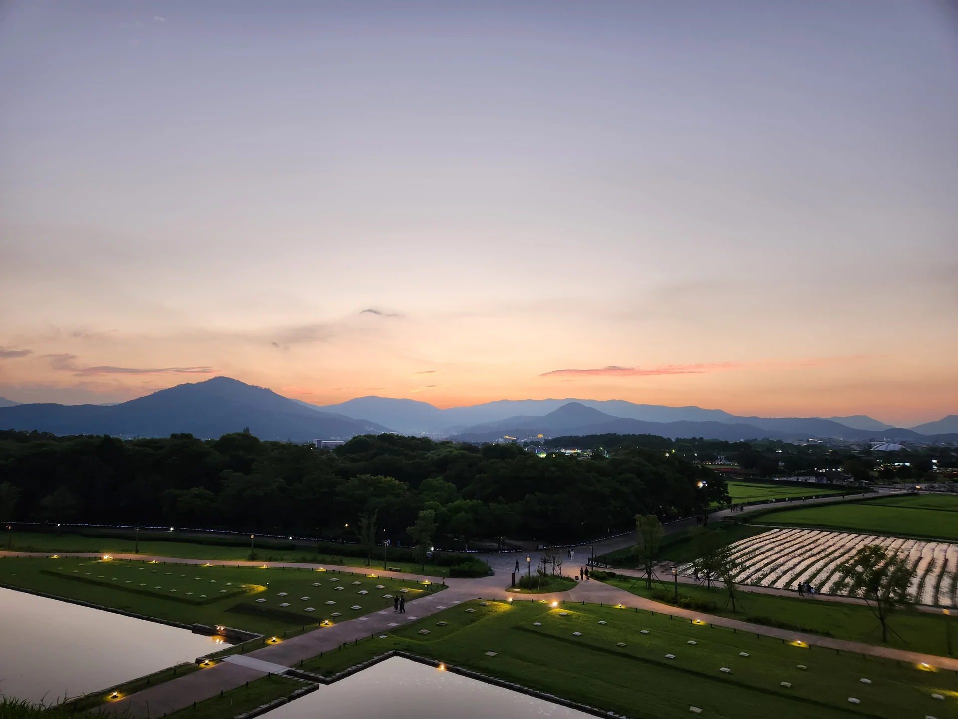 Transform your phone with the inviting green spaces of Korea's parks and gardens. From the sprawling lawns of Olympic Park in Seoul to the meticulously landscaped botanical gardens of the southern coast, these wallpapers capture the beauty of Korea's curated natural spaces — blooming flower beds, reflective lotus ponds, tree-lined promenades, and autumn foliage canopies.

Korean parks are designed for contemplation, and it shows in every image: stone pathways curving around still water, wooden pavilions framed by seasonal color, cherry-blossom tunnels creating pink corridors, and wide meadows where families gather under open skies. Free download these aesthetic park wallpapers and give your phone background the refreshing energy of a Korean garden escape., Inwang-dong, Wolseong-dong, Gyeongju-si — Free Korean aesthetic wallpaper