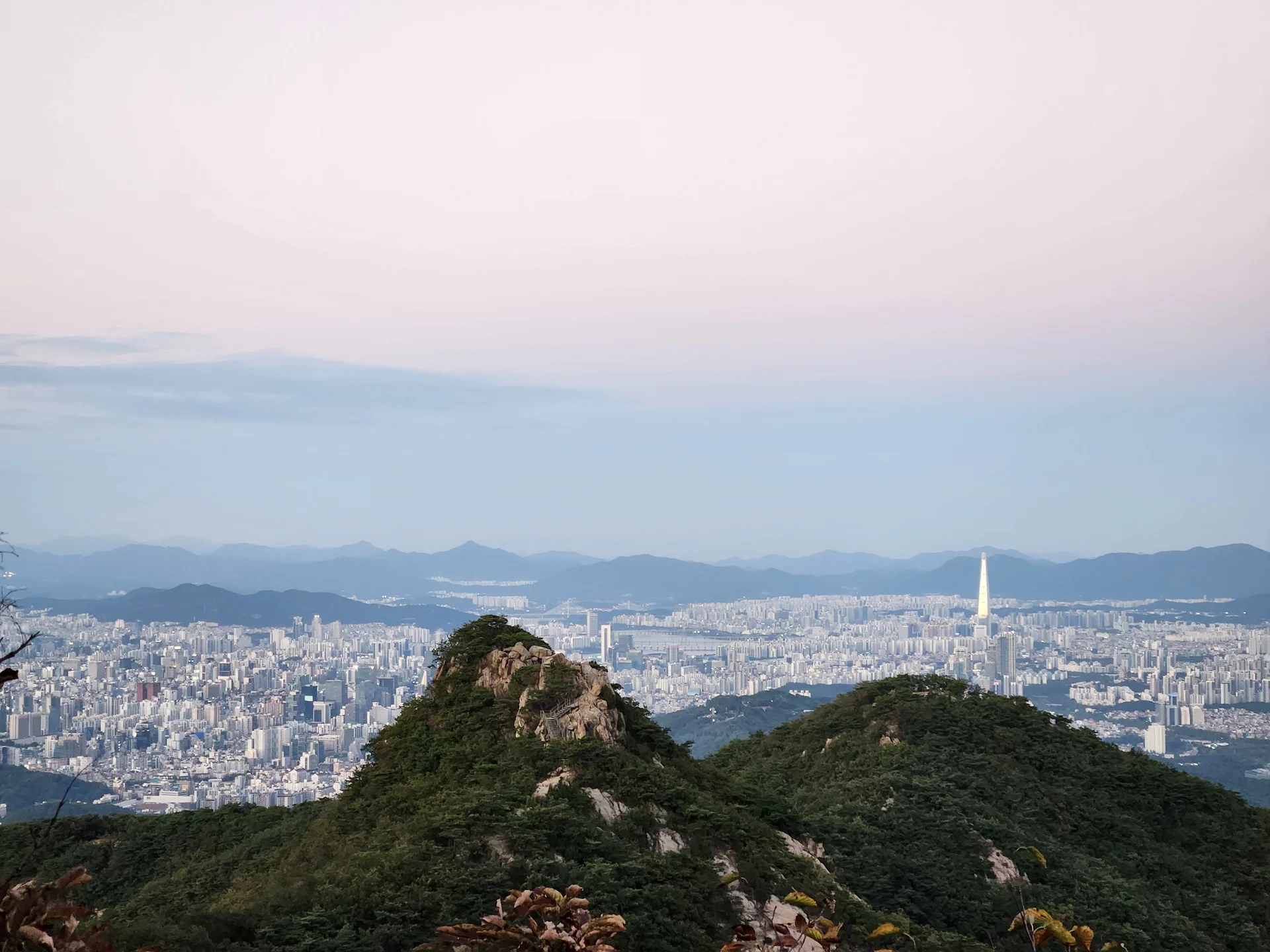 Immerse your screen in the untouched beauty of Korea's natural world. These Korean wallpapers feature sweeping countryside fields blanketed in green, hidden valleys where morning mist clings to the hillsides, and winding streams cutting through rocky terrain. Each photo captures the raw, peaceful energy that makes Korea's landscapes so distinctive.

From the volcanic plains of Jeju Island to the lush wetlands of Suncheon Bay, this collection showcases nature in every mood — dramatic storm clouds rolling over ridgelines, golden sunlight filtering through canopy gaps, and wildflower meadows stretching toward distant peaks. Download these aesthetic phone backgrounds for free and bring a moment of Korean tranquility to your daily life., Gwacheon knowledge information town, Gwacheon-si — Free Korean aesthetic wallpaper