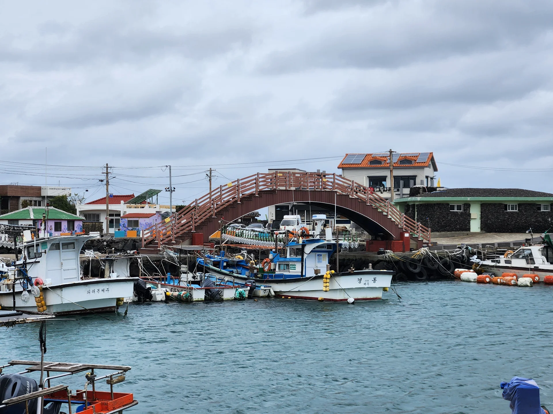 Bring the Korean coastline to your phone with these breathtaking ocean wallpapers. Korea is surrounded by water on three sides, and this collection captures it all — the turquoise shallows of Jeju's beaches, dramatic basalt cliffs plunging into the East Sea, tranquil fishing harbors at dawn, and endless Pacific horizons glowing under golden light.

These photos feature crashing waves against volcanic rock formations, serene island silhouettes at sunset, lighthouse beacons cutting through coastal fog, and the mirror-still surface of sheltered bays reflecting cotton-candy skies. Download these free Korean sea wallpapers for an aesthetic phone background that carries the calm and power of the ocean wherever you go., Bukchon 11-gil, Jeju — Free Korean aesthetic wallpaper