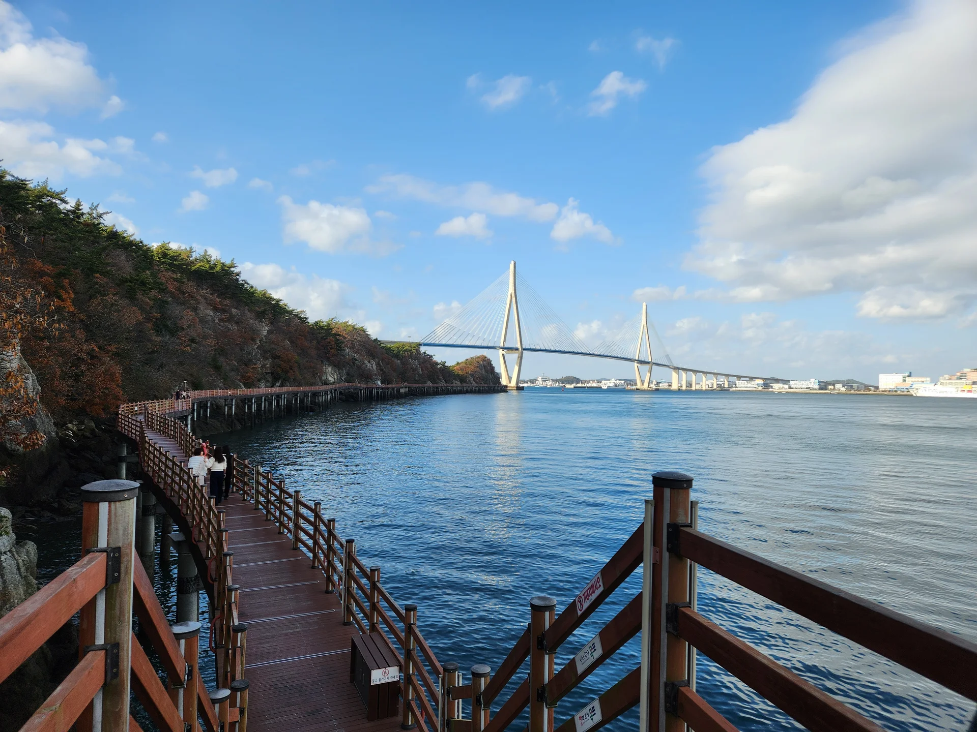 Bring the Korean coastline to your phone with these breathtaking ocean wallpapers. Korea is surrounded by water on three sides, and this collection captures it all — the turquoise shallows of Jeju's beaches, dramatic basalt cliffs plunging into the East Sea, tranquil fishing harbors at dawn, and endless Pacific horizons glowing under golden light.

These photos feature crashing waves against volcanic rock formations, serene island silhouettes at sunset, lighthouse beacons cutting through coastal fog, and the mirror-still surface of sheltered bays reflecting cotton-candy skies. Download these free Korean sea wallpapers for an aesthetic phone background that carries the calm and power of the ocean wherever you go., Mokpo-si, Jeollanam-do — Free Korean aesthetic wallpaper