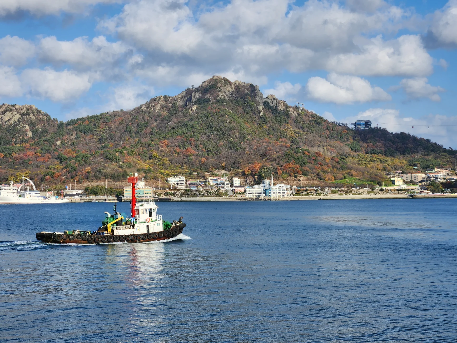 Bring the Korean coastline to your phone with these breathtaking ocean wallpapers. Korea is surrounded by water on three sides, and this collection captures it all — the turquoise shallows of Jeju's beaches, dramatic basalt cliffs plunging into the East Sea, tranquil fishing harbors at dawn, and endless Pacific horizons glowing under golden light.

These photos feature crashing waves against volcanic rock formations, serene island silhouettes at sunset, lighthouse beacons cutting through coastal fog, and the mirror-still surface of sheltered bays reflecting cotton-candy skies. Download these free Korean sea wallpapers for an aesthetic phone background that carries the calm and power of the ocean wherever you go., Mokpo-si, Jeollanam-do — Free Korean aesthetic wallpaper