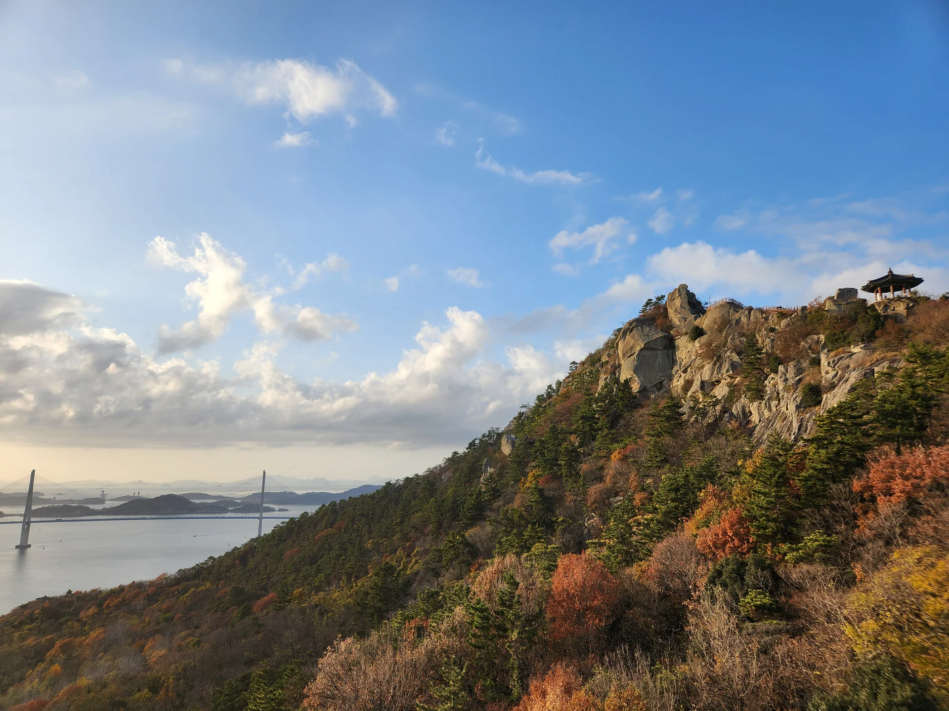 Set your phone against the majestic backdrop of Korea's mountain ranges. The Korean peninsula is nearly 70% mountainous, and these wallpapers celebrate that dramatic terrain — jagged granite peaks rising above the clouds, ancient fortress walls tracing ridgelines, and forest trails disappearing into autumn-colored valleys.

From the iconic rocky summits of Bukhansan in Seoul to the remote alpine meadows of Seoraksan, each image captures the scale and serenity of Korean mountain landscapes across all four seasons. Snow-dusted winter peaks, spring azalea blooms on hillsides, summer greenery, and fiery fall foliage are all here. Free download these aesthetic mountain wallpapers and carry Korea's highland grandeur in your pocket., Mokpo-si, Jeollanam-do — Free Korean aesthetic wallpaper