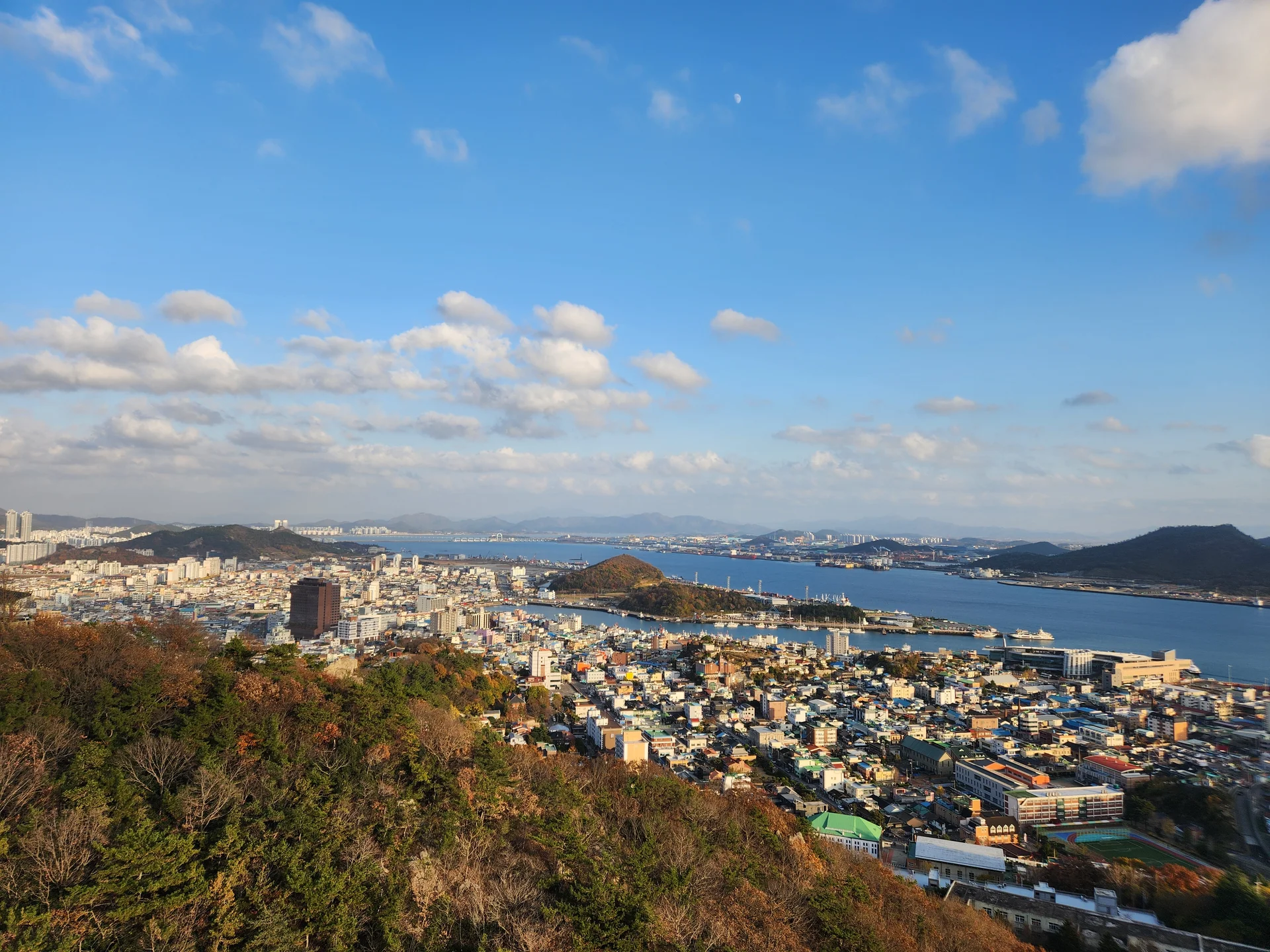 Bring the Korean coastline to your phone with these breathtaking ocean wallpapers. Korea is surrounded by water on three sides, and this collection captures it all — the turquoise shallows of Jeju's beaches, dramatic basalt cliffs plunging into the East Sea, tranquil fishing harbors at dawn, and endless Pacific horizons glowing under golden light.

These photos feature crashing waves against volcanic rock formations, serene island silhouettes at sunset, lighthouse beacons cutting through coastal fog, and the mirror-still surface of sheltered bays reflecting cotton-candy skies. Download these free Korean sea wallpapers for an aesthetic phone background that carries the calm and power of the ocean wherever you go., Mokpo-si, Jeollanam-do — Free Korean aesthetic wallpaper