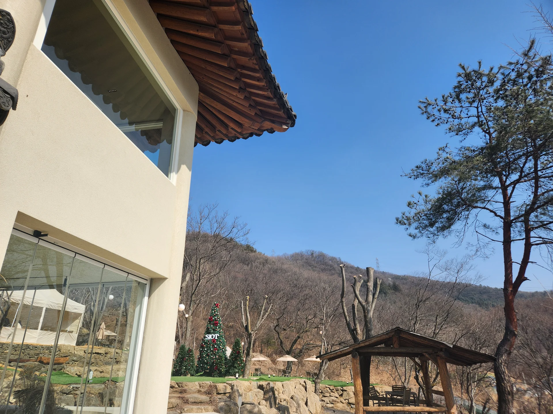 Adorn your phone with the timeless elegance of hanok, Korea's traditional wooden houses. These wallpapers showcase the graceful curved rooflines, hand-carved wooden lattice doors, and serene inner courtyards that have defined Korean residential architecture for centuries. Preserved hanok villages in Bukchon and Jeonju offer a living window into Korea's past.

Each image reveals the quiet beauty of these heritage homes — clay walls weathered to warm earth tones, dark timber frames contrasting with paper-screened windows, stone foundations meeting manicured courtyard gardens, and traditional eaves silhouetted against modern skylines. Download these free hanok wallpapers for an aesthetic phone background that celebrates the harmony between Korean tradition and contemporary life., Namhansanseong-ro, Gwangju-si — Free Korean aesthetic wallpaper