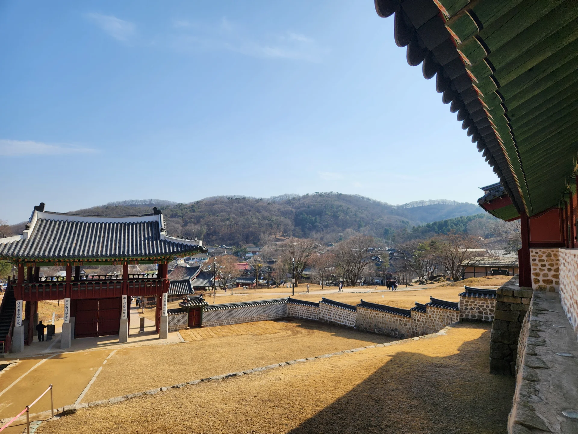 Adorn your phone with the timeless elegance of hanok, Korea's traditional wooden houses. These wallpapers showcase the graceful curved rooflines, hand-carved wooden lattice doors, and serene inner courtyards that have defined Korean residential architecture for centuries. Preserved hanok villages in Bukchon and Jeonju offer a living window into Korea's past.

Each image reveals the quiet beauty of these heritage homes — clay walls weathered to warm earth tones, dark timber frames contrasting with paper-screened windows, stone foundations meeting manicured courtyard gardens, and traditional eaves silhouetted against modern skylines. Download these free hanok wallpapers for an aesthetic phone background that celebrates the harmony between Korean tradition and contemporary life., Namhansanseong-ro 792beon-gil, Gwangju-si — Free Korean aesthetic wallpaper