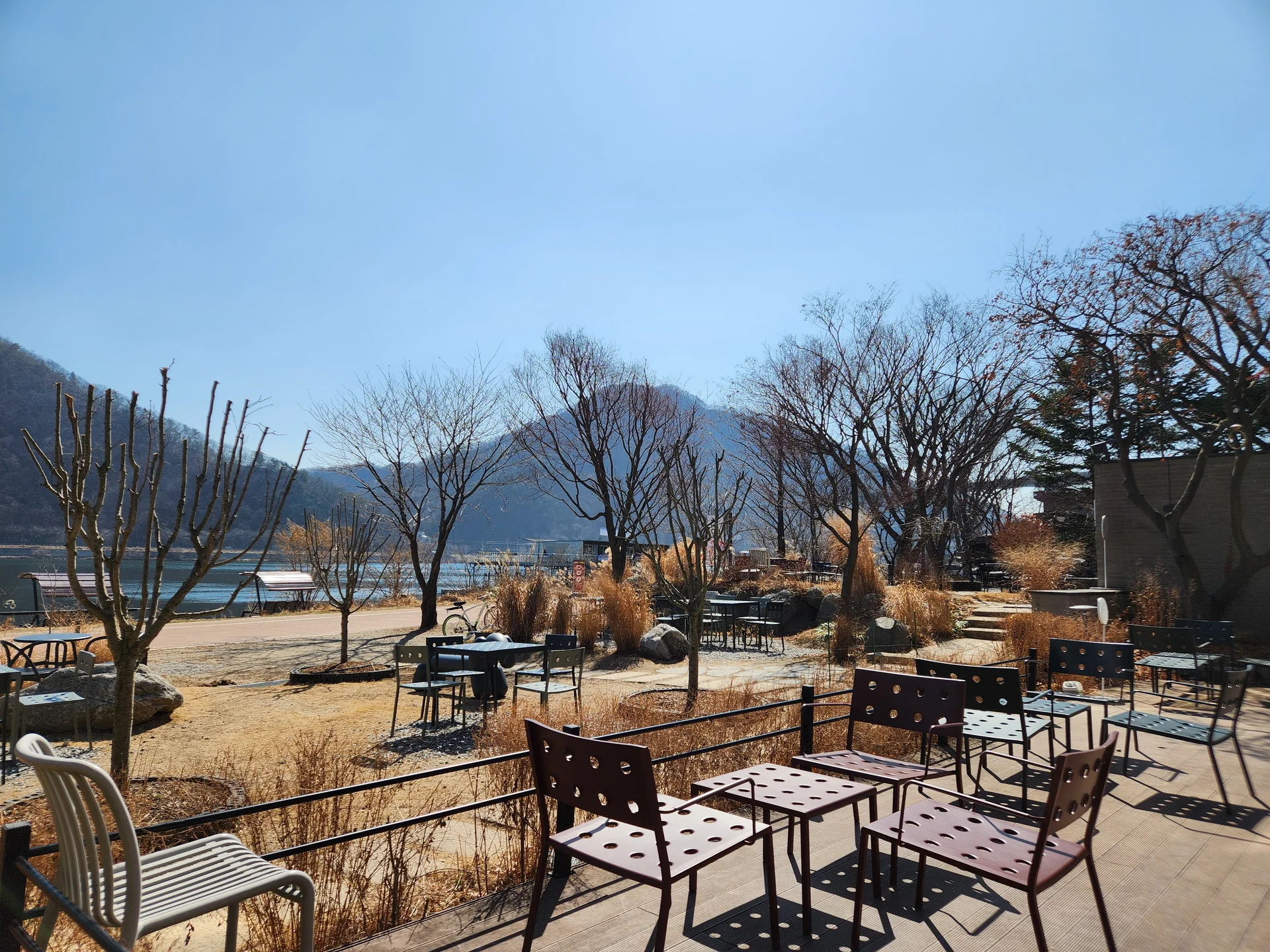 Wrap your phone in the cozy, Instagram-worthy atmosphere of Korean cafe culture. Korea's cafes are more than coffee shops — they're design experiences. These wallpapers feature warm interior light falling on minimalist wooden counters, perfectly crafted latte art in handmade ceramic cups, floor-to-ceiling windows overlooking quiet streets, and rooftop terraces with city panoramas.

From industrial-chic converted warehouses in Seongsu to tiny hidden basement cafes in Ikseon-dong, each image captures the aesthetic sensibility that makes Korean cafe design world-famous. Trailing plants, warm Edison bulbs, curated book walls, and the soft golden glow of afternoon light create scenes you'll want to stare at. Download these free Korean cafe wallpapers for a phone background that feels like a warm hug., Bukhangang-ro, Namyangju-si — Free Korean aesthetic wallpaper