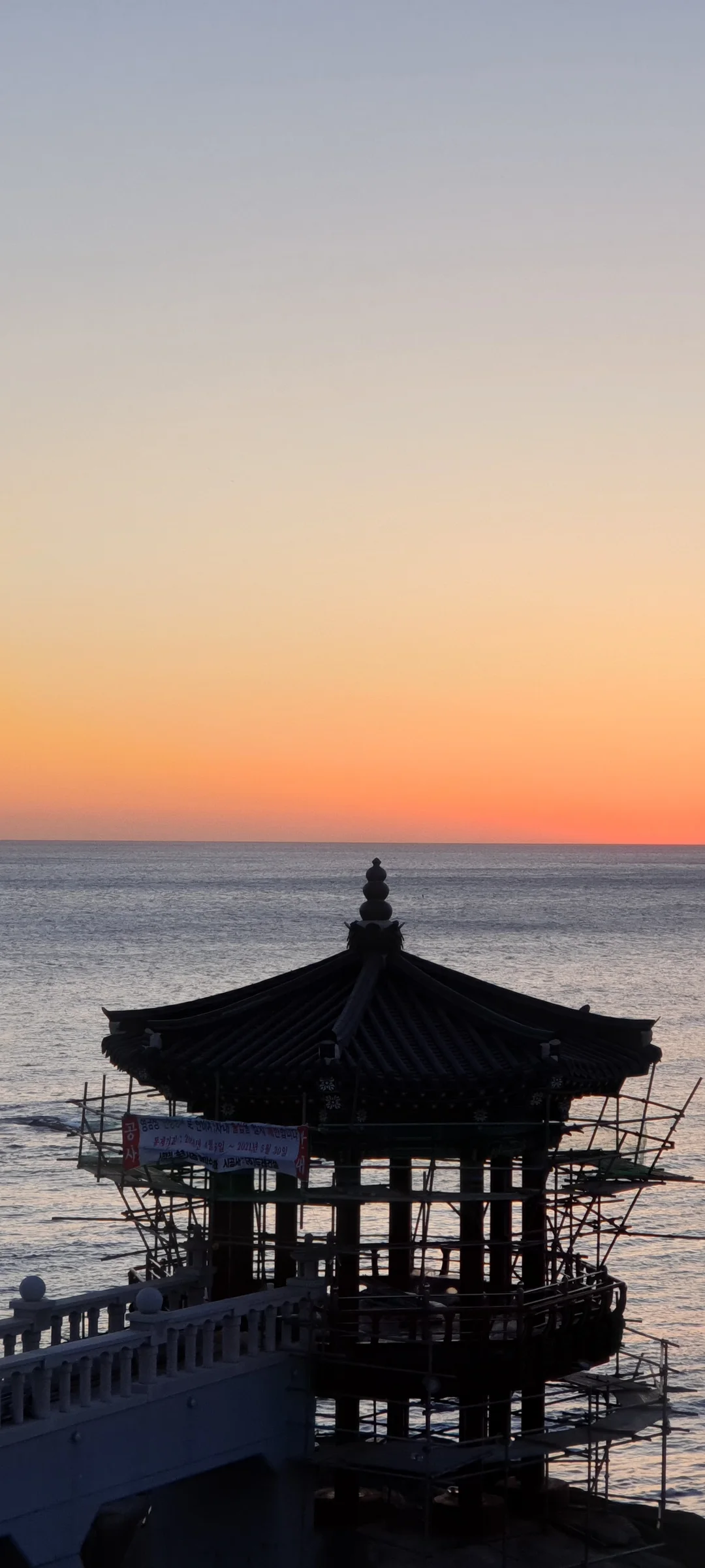 Bring the Korean coastline to your phone with these breathtaking ocean wallpapers. Korea is surrounded by water on three sides, and this collection captures it all — the turquoise shallows of Jeju's beaches, dramatic basalt cliffs plunging into the East Sea, tranquil fishing harbors at dawn, and endless Pacific horizons glowing under golden light.

These photos feature crashing waves against volcanic rock formations, serene island silhouettes at sunset, lighthouse beacons cutting through coastal fog, and the mirror-still surface of sheltered bays reflecting cotton-candy skies. Download these free Korean sea wallpapers for an aesthetic phone background that carries the calm and power of the ocean wherever you go., Sokcho, Gangwon-do — Free Korean aesthetic wallpaper