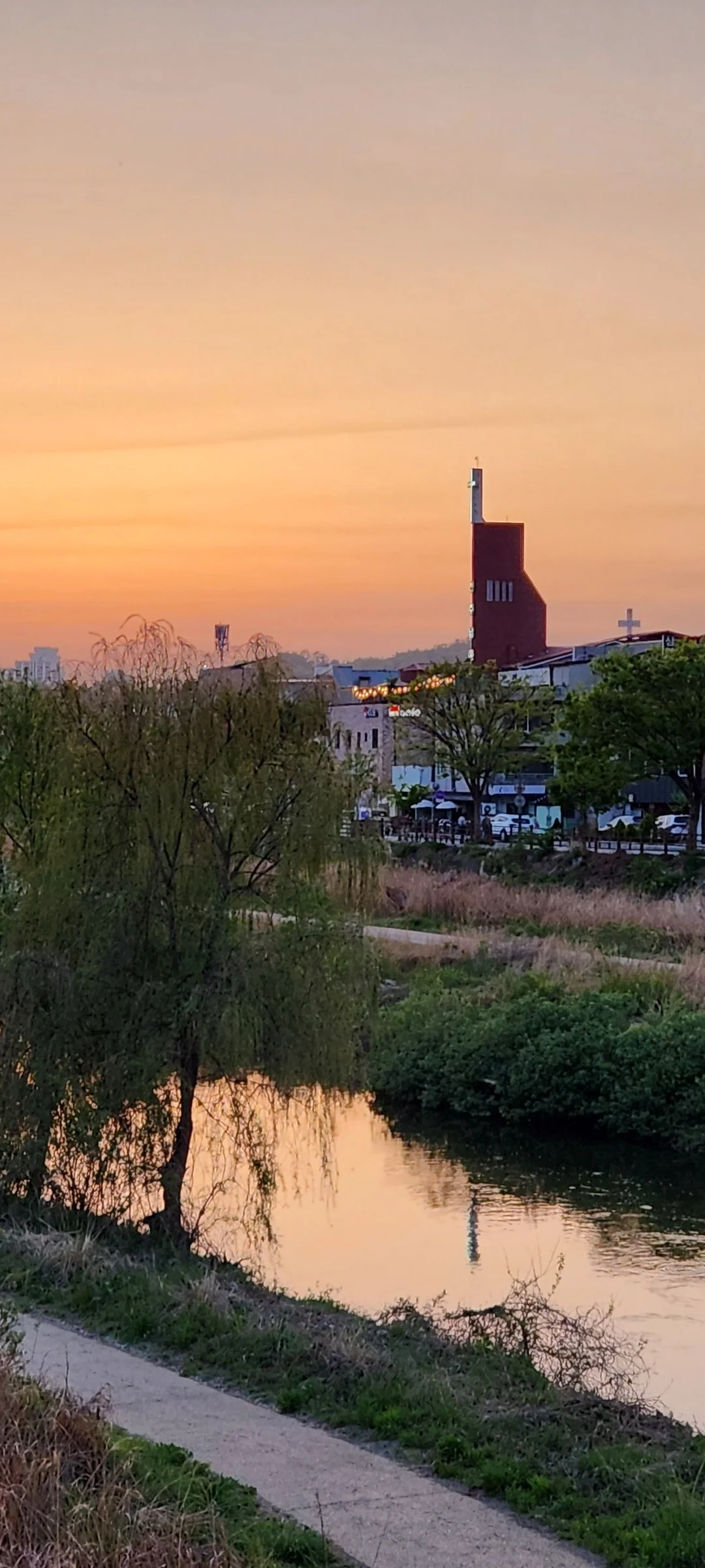 Bring the peaceful flow of Korea's waterways to your phone screen. These river wallpapers feature the iconic Han River cutting through Seoul's skyline, its surface mirroring city lights at dusk, as well as serene lakeside scenes from the countryside where mountains descend to meet still water and morning fog drifts across the surface.

From riverside cycling paths lined with cherry blossoms to dramatic reflections of autumn foliage in mountain streams, each image captures the calming presence of water in Korean landscapes. Waterfront pavilions, stone bridges arching over gentle currents, and lone boats floating in golden light are all waiting here. Download these free Korean river wallpapers for an aesthetic phone background full of tranquility., Jeonjucheonseo-ro, Jeon-dong, Jeonju-si — Free Korean aesthetic wallpaper