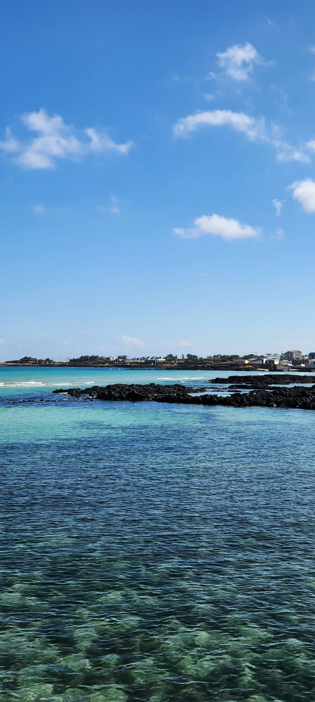 Bring the Korean coastline to your phone with these breathtaking ocean wallpapers. Korea is surrounded by water on three sides, and this collection captures it all — the turquoise shallows of Jeju's beaches, dramatic basalt cliffs plunging into the East Sea, tranquil fishing harbors at dawn, and endless Pacific horizons glowing under golden light.

These photos feature crashing waves against volcanic rock formations, serene island silhouettes at sunset, lighthouse beacons cutting through coastal fog, and the mirror-still surface of sheltered bays reflecting cotton-candy skies. Download these free Korean sea wallpapers for an aesthetic phone background that carries the calm and power of the ocean wherever you go., Haemajihaean-ro, Jeju — Free Korean aesthetic wallpaper