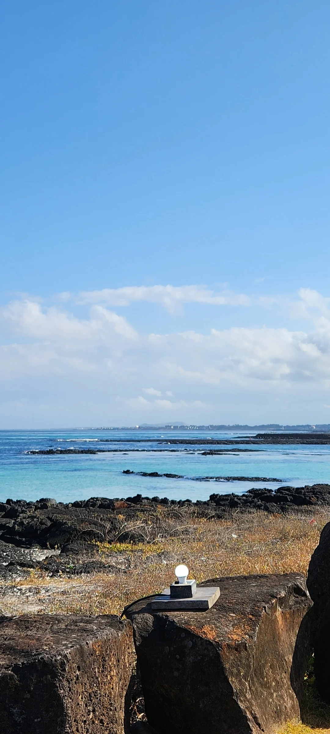 Bring the Korean coastline to your phone with these breathtaking ocean wallpapers. Korea is surrounded by water on three sides, and this collection captures it all — the turquoise shallows of Jeju's beaches, dramatic basalt cliffs plunging into the East Sea, tranquil fishing harbors at dawn, and endless Pacific horizons glowing under golden light.

These photos feature crashing waves against volcanic rock formations, serene island silhouettes at sunset, lighthouse beacons cutting through coastal fog, and the mirror-still surface of sheltered bays reflecting cotton-candy skies. Download these free Korean sea wallpapers for an aesthetic phone background that carries the calm and power of the ocean wherever you go., Haemajihaean-ro, Jeju — Free Korean aesthetic wallpaper