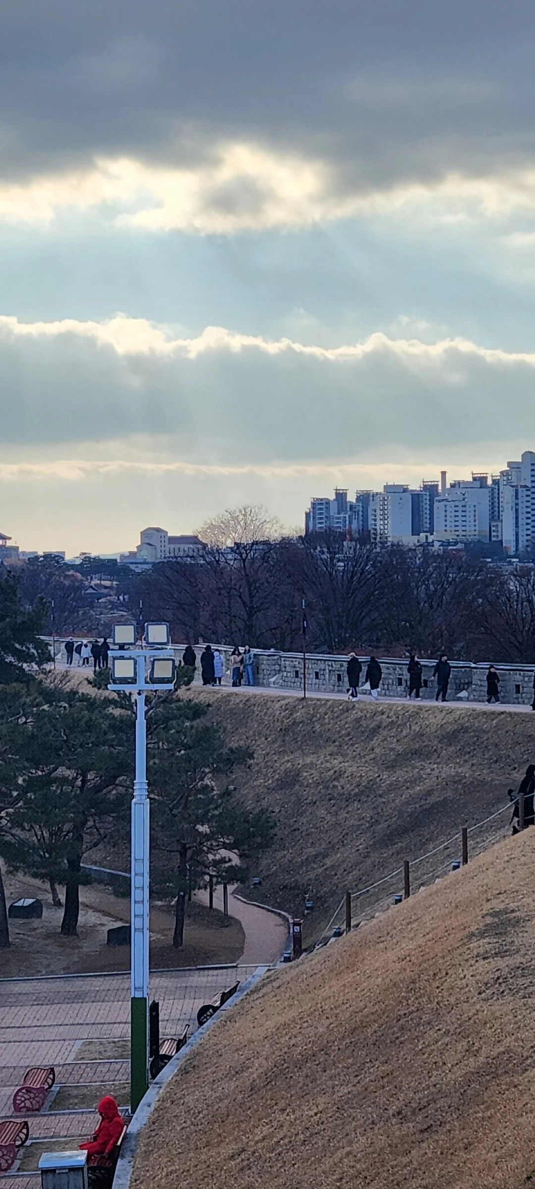 Explore Korea's architectural landscape through stunning phone wallpapers that span centuries of design. From the sleek glass curtain walls of Gangnam's skyscrapers to the raw concrete forms of brutalist apartment complexes, these images capture how Korea blends cutting-edge modernity with bold structural expression.

Look closer and you'll discover geometric patterns in subway station ceilings, sweeping curves of the Dongdaemun Design Plaza, and the quiet symmetry of traditional gate structures standing beside high-rises. Whether you're drawn to minimalist Korean design or dramatic urban geometry, these free aesthetic wallpapers transform your phone background into a gallery of architectural photography., Jangan-dong, 팔달구, Suwon-si — Free Korean aesthetic wallpaper