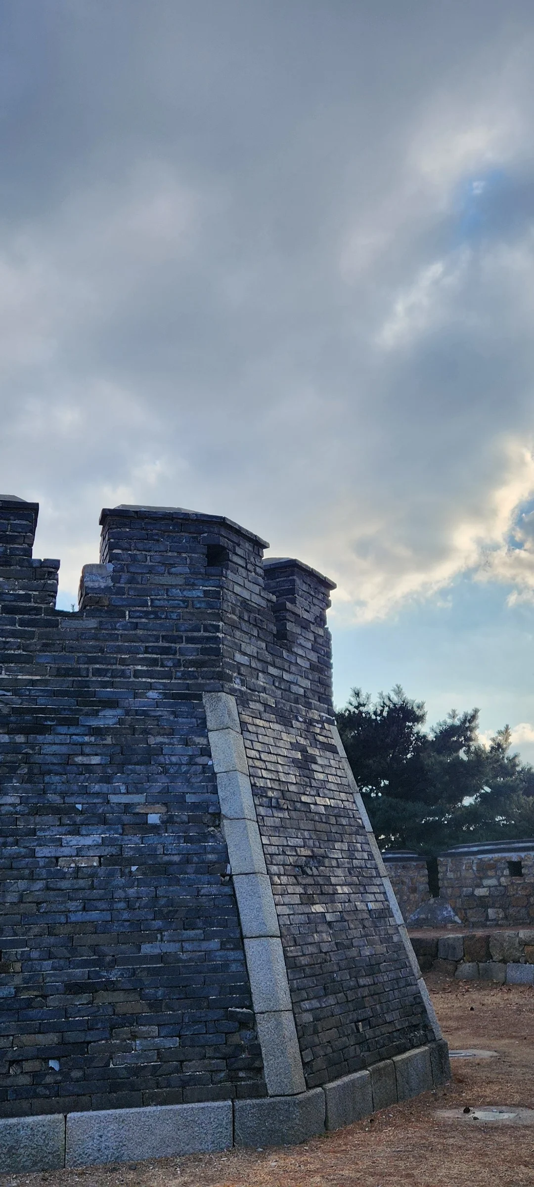 Explore Korea's architectural landscape through stunning phone wallpapers that span centuries of design. From the sleek glass curtain walls of Gangnam's skyscrapers to the raw concrete forms of brutalist apartment complexes, these images capture how Korea blends cutting-edge modernity with bold structural expression.

Look closer and you'll discover geometric patterns in subway station ceilings, sweeping curves of the Dongdaemun Design Plaza, and the quiet symmetry of traditional gate structures standing beside high-rises. Whether you're drawn to minimalist Korean design or dramatic urban geometry, these free aesthetic wallpapers transform your phone background into a gallery of architectural photography., Paldalsan-ro, Namchang-dong, 팔달구, Suwon-si — Free Korean aesthetic wallpaper