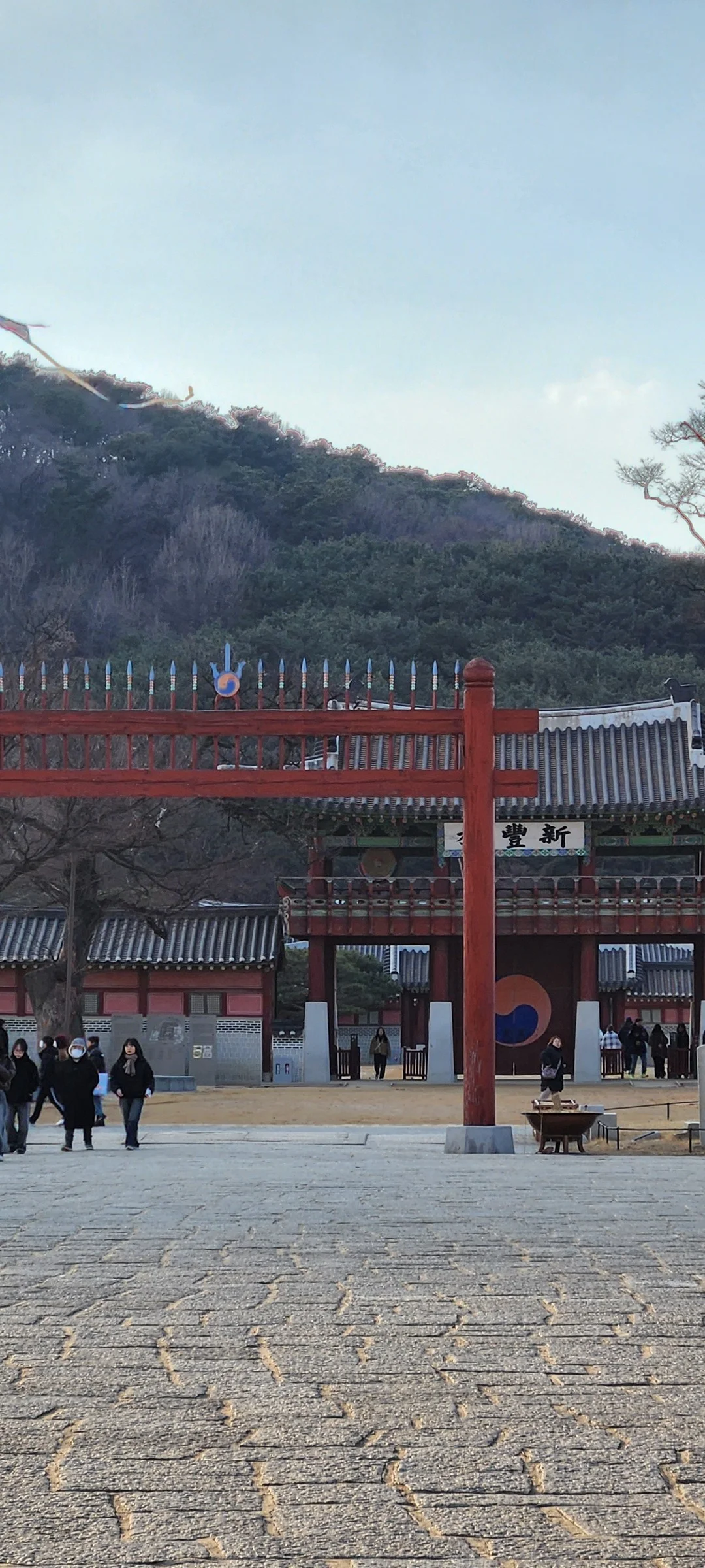 Explore Korea's architectural landscape through stunning phone wallpapers that span centuries of design. From the sleek glass curtain walls of Gangnam's skyscrapers to the raw concrete forms of brutalist apartment complexes, these images capture how Korea blends cutting-edge modernity with bold structural expression.

Look closer and you'll discover geometric patterns in subway station ceilings, sweeping curves of the Dongdaemun Design Plaza, and the quiet symmetry of traditional gate structures standing beside high-rises. Whether you're drawn to minimalist Korean design or dramatic urban geometry, these free aesthetic wallpapers transform your phone background into a gallery of architectural photography., Hwaseong Haenggung Square, Paldallo 1-ga, 팔달구, Suwon-si — Free Korean aesthetic wallpaper