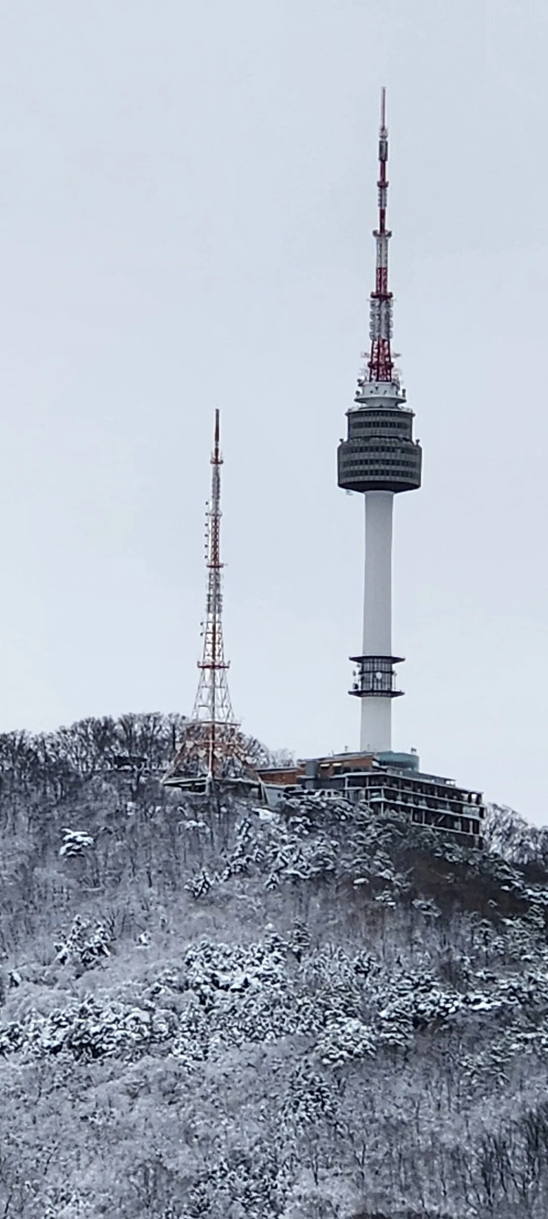 Explore Korea's architectural landscape through stunning phone wallpapers that span centuries of design. From the sleek glass curtain walls of Gangnam's skyscrapers to the raw concrete forms of brutalist apartment complexes, these images capture how Korea blends cutting-edge modernity with bold structural expression.

Look closer and you'll discover geometric patterns in subway station ceilings, sweeping curves of the Dongdaemun Design Plaza, and the quiet symmetry of traditional gate structures standing beside high-rises. Whether you're drawn to minimalist Korean design or dramatic urban geometry, these free aesthetic wallpapers transform your phone background into a gallery of architectural photography., Baekbeom-ro 90-gil, Wonhyoro 1(iI)-dong, Seoul — Free Korean aesthetic wallpaper