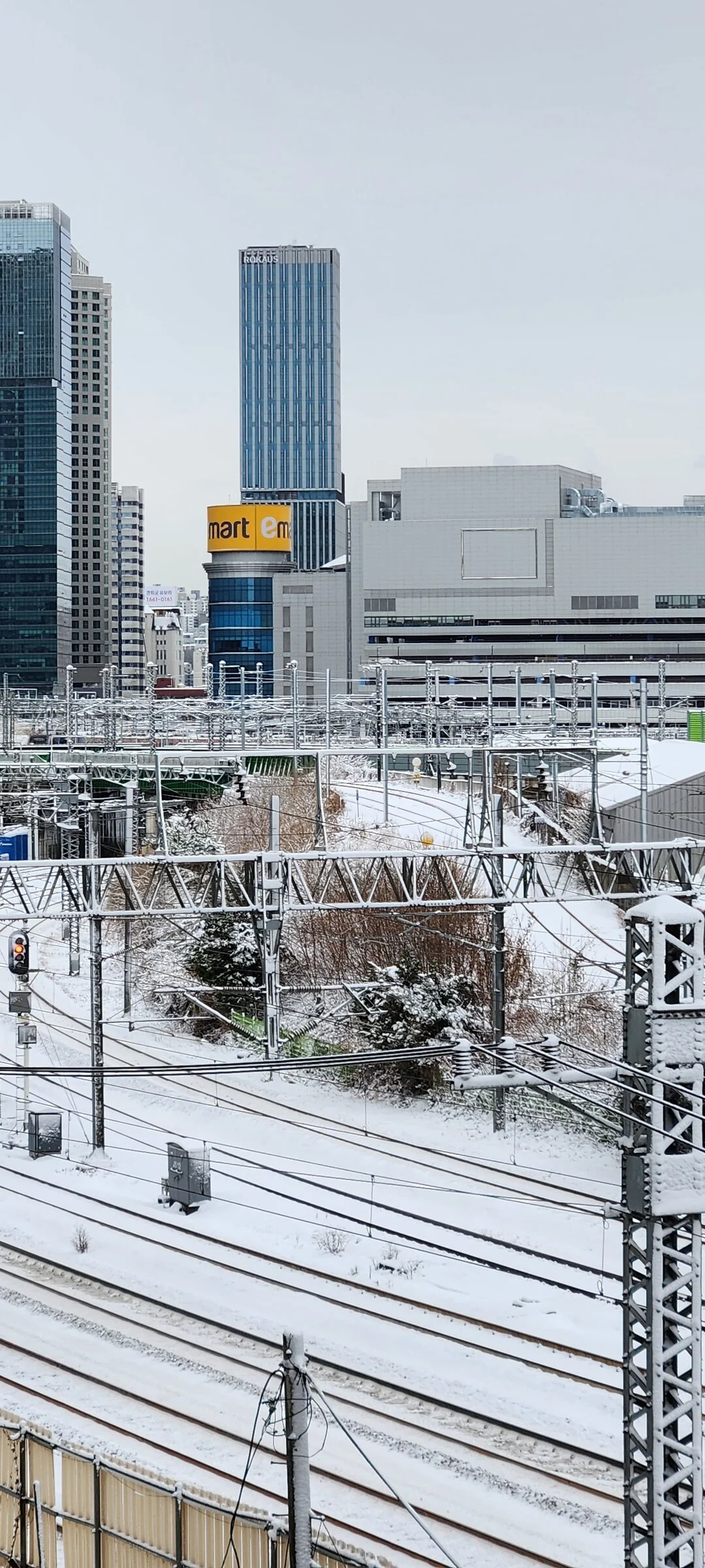 Experience the vibrant pulse of Korean city life through these dynamic street wallpapers. Bustling crosswalks in Myeongdong, colorful shop fronts in Hongdae, rain-slicked sidewalks reflecting neon signs, and everyday moments of commuters, street vendors, and cyclists moving through Seoul's urban rhythm — each image tells a story of a city constantly in motion.

Beyond Seoul, you'll find the charming streetscapes of Busan's hillside neighborhoods, the retro storefronts of Jeonju, and quiet residential lanes where laundry dries on balconies above parked scooters. These free Korean street wallpapers are perfect as an aesthetic phone background for anyone captivated by the raw energy and visual richness of Korean urban culture., Baekbeom-ro 99-gil, Hangangno-dong, Seoul — Free Korean aesthetic wallpaper