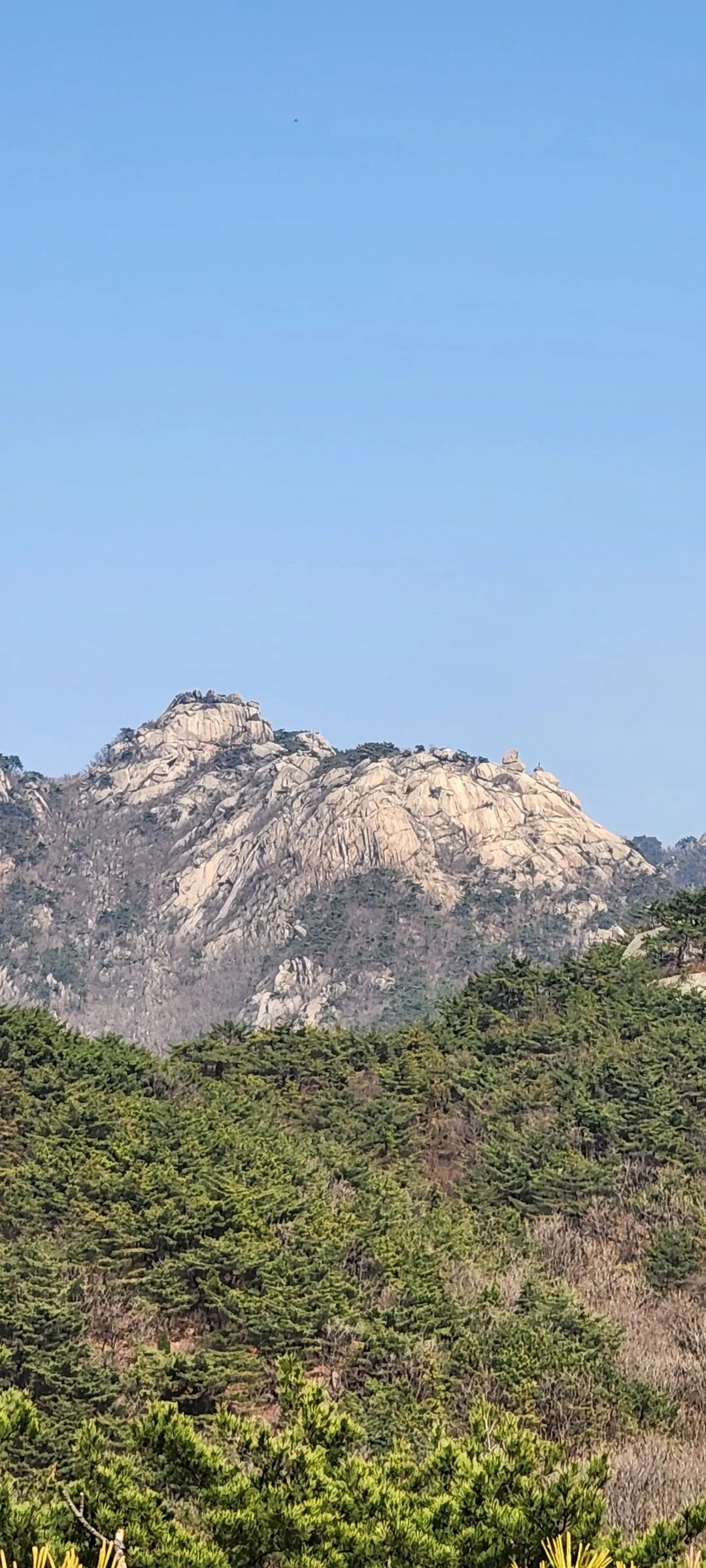 Set your phone against the majestic backdrop of Korea's mountain ranges. The Korean peninsula is nearly 70% mountainous, and these wallpapers celebrate that dramatic terrain — jagged granite peaks rising above the clouds, ancient fortress walls tracing ridgelines, and forest trails disappearing into autumn-colored valleys.

From the iconic rocky summits of Bukhansan in Seoul to the remote alpine meadows of Seoraksan, each image captures the scale and serenity of Korean mountain landscapes across all four seasons. Snow-dusted winter peaks, spring azalea blooms on hillsides, summer greenery, and fiery fall foliage are all here. Free download these aesthetic mountain wallpapers and carry Korea's highland grandeur in your pocket., Samobawi, Pyeongchang-dong, Seoul — Free Korean aesthetic wallpaper