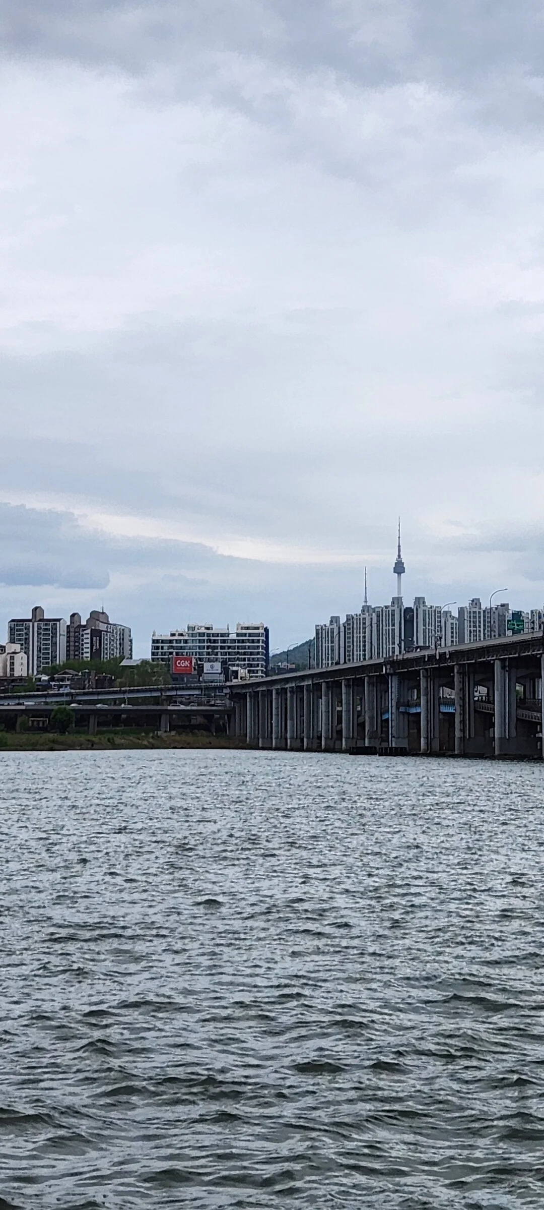 Bring the peaceful flow of Korea's waterways to your phone screen. These river wallpapers feature the iconic Han River cutting through Seoul's skyline, its surface mirroring city lights at dusk, as well as serene lakeside scenes from the countryside where mountains descend to meet still water and morning fog drifts across the surface.

From riverside cycling paths lined with cherry blossoms to dramatic reflections of autumn foliage in mountain streams, each image captures the calming presence of water in Korean landscapes. Waterfront pavilions, stone bridges arching over gentle currents, and lone boats floating in golden light are all waiting here. Download these free Korean river wallpapers for an aesthetic phone background full of tranquility., Banpodaero, Banpo 2(i)-dong, Seoul — Free Korean aesthetic wallpaper