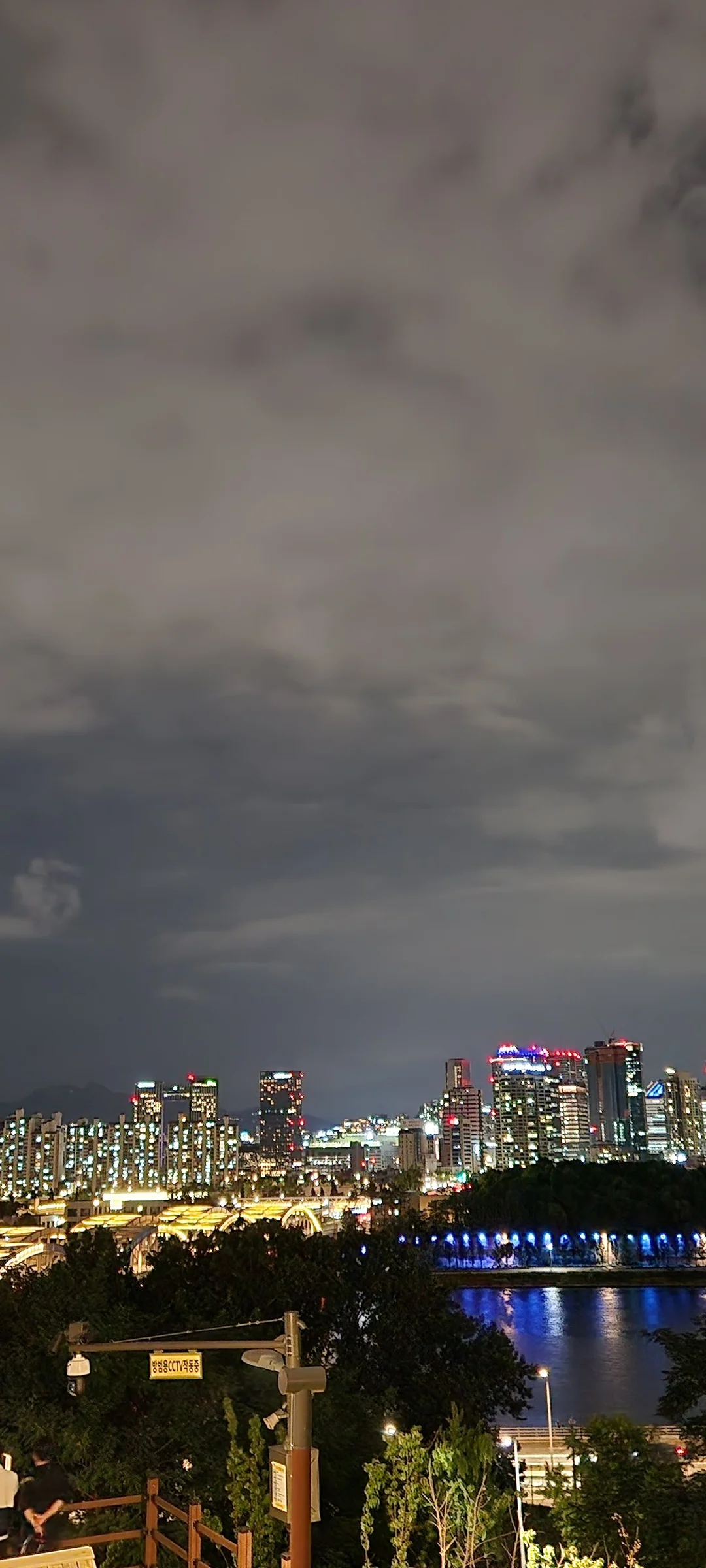 Light up your phone with the electric energy of Seoul after dark. These Korean nightscape wallpapers capture the city at its most cinematic — neon signage stacking up narrow alleyways, glowing street food stalls sending steam into cold night air, illuminated bridges spanning the Han River, and the shimmering towers of Gangnam reflected in rain-wet streets.

Seoul's nighttime personality is bold, colorful, and endlessly photogenic. You'll find the moody glow of Itaewon bars, the cyberpunk atmosphere of Euljiro's industrial blocks, and panoramic cityscapes from hilltop viewpoints where the city stretches to the horizon in every direction. Free download these aesthetic Seoul night wallpapers for a phone background that pulses with urban energy., Nodeul-ro, Noryangjin 1(il)-dong, Seoul — Free Korean aesthetic wallpaper