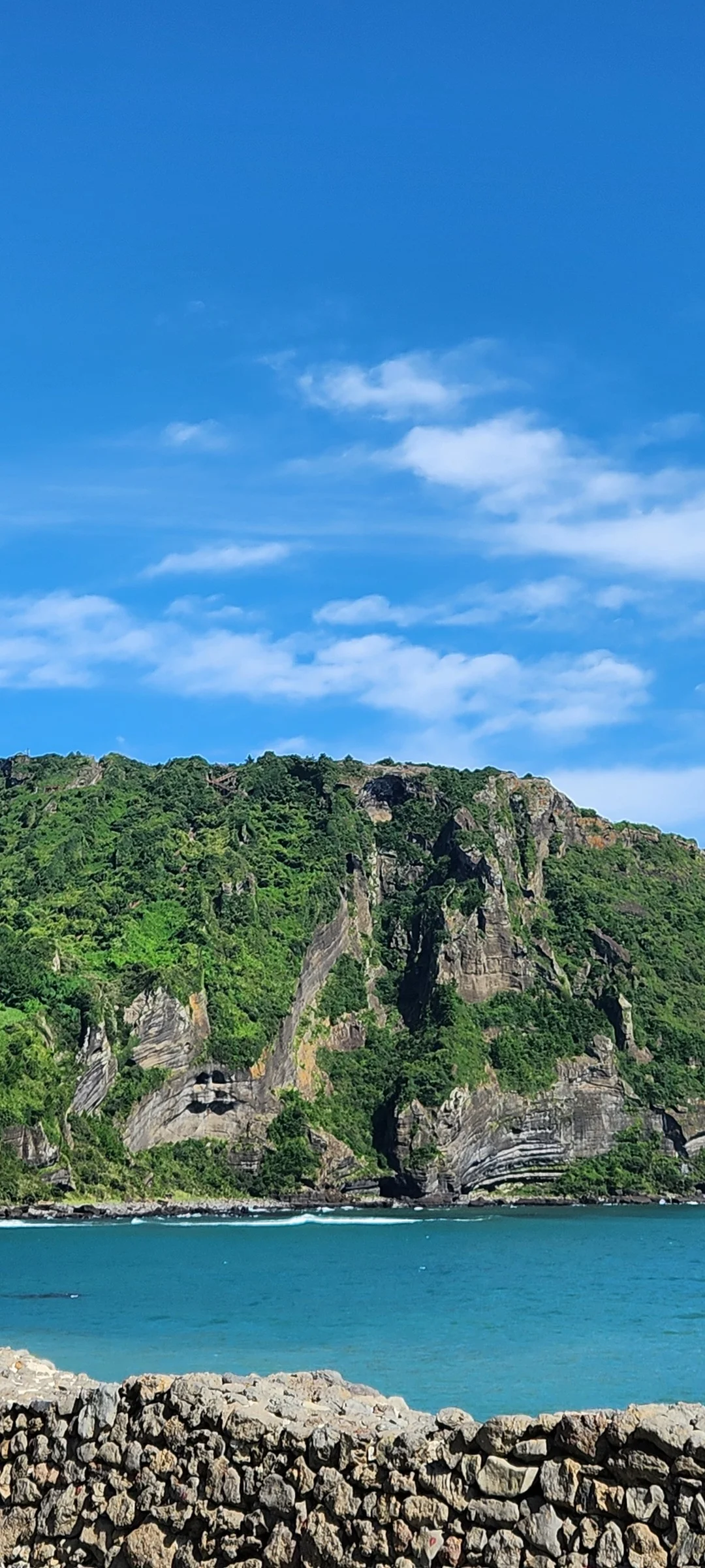 Immerse your screen in the untouched beauty of Korea's natural world. These Korean wallpapers feature sweeping countryside fields blanketed in green, hidden valleys where morning mist clings to the hillsides, and winding streams cutting through rocky terrain. Each photo captures the raw, peaceful energy that makes Korea's landscapes so distinctive.

From the volcanic plains of Jeju Island to the lush wetlands of Suncheon Bay, this collection showcases nature in every mood — dramatic storm clouds rolling over ridgelines, golden sunlight filtering through canopy gaps, and wildflower meadows stretching toward distant peaks. Download these aesthetic phone backgrounds for free and bring a moment of Korean tranquility to your daily life., Ilchul-ro, Seogwipo-si — Free Korean aesthetic wallpaper