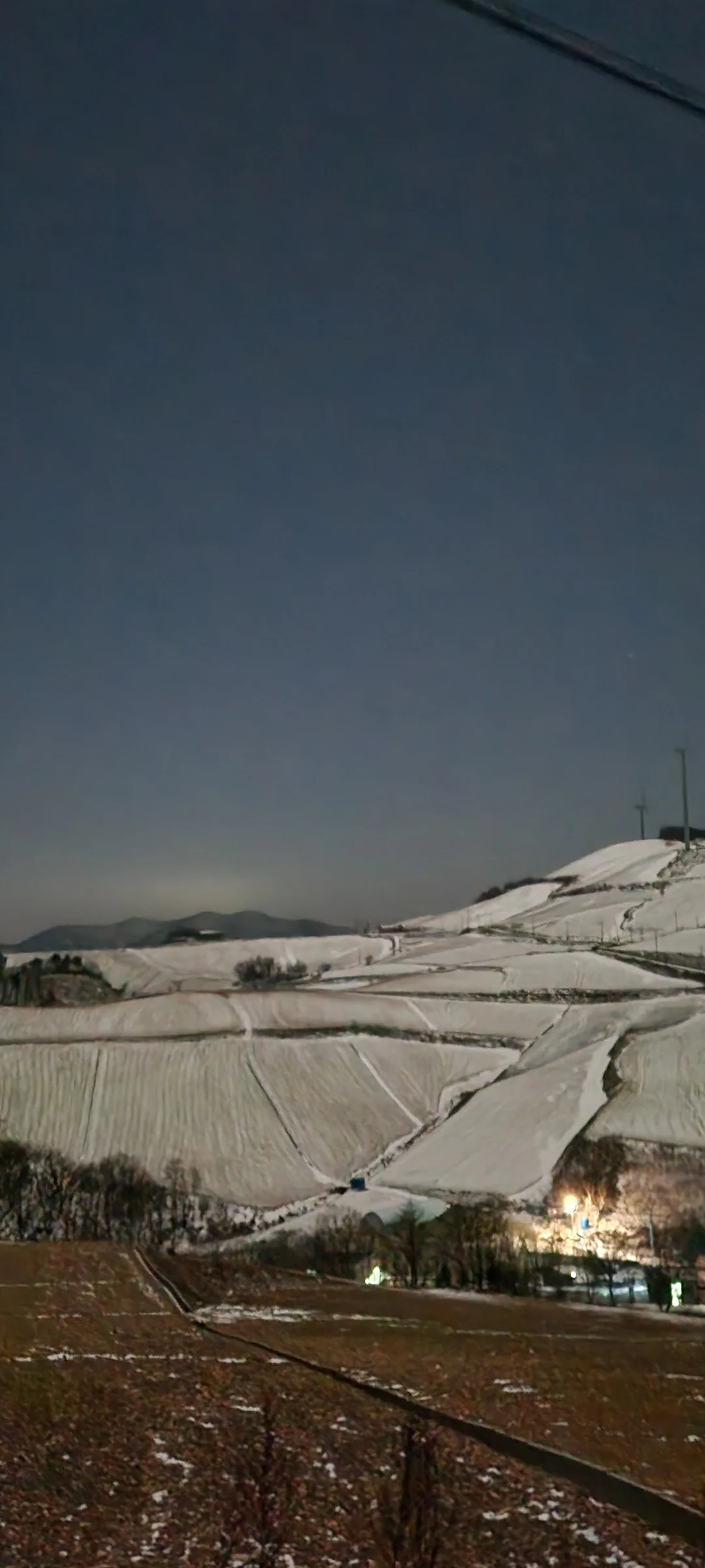 Transform your phone into a Korean winter wonderland with these snowy wallpapers. Freshly fallen snow blankets ancient temple rooftops, frost crystals cling to bare branches in perfect geometric patterns, and quiet village streets become pristine white corridors under heavy winter skies. Korea's winters are cold but visually stunning, and these images capture that magic.

You'll find snow-draped palace courtyards in Seoul, frozen mountain streams framed by icy rock walls, bamboo groves bowing under the weight of fresh powder, and soft footprints trailing through untouched snowfields at dawn. Download these free Korean snow wallpapers for an aesthetic phone background that brings the crisp, peaceful beauty of a Korean winter to your screen year-round., 안반데기2길, 왕산면, Gangneung-si — Free Korean aesthetic wallpaper