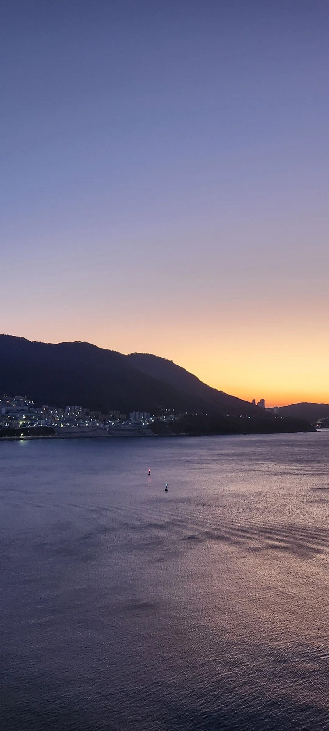 Bring the Korean coastline to your phone with these breathtaking ocean wallpapers. Korea is surrounded by water on three sides, and this collection captures it all — the turquoise shallows of Jeju's beaches, dramatic basalt cliffs plunging into the East Sea, tranquil fishing harbors at dawn, and endless Pacific horizons glowing under golden light.

These photos feature crashing waves against volcanic rock formations, serene island silhouettes at sunset, lighthouse beacons cutting through coastal fog, and the mirror-still surface of sheltered bays reflecting cotton-candy skies. Download these free Korean sea wallpapers for an aesthetic phone background that carries the calm and power of the ocean wherever you go., Deungdae-ro, Seo-gu, Busan — Free Korean aesthetic wallpaper