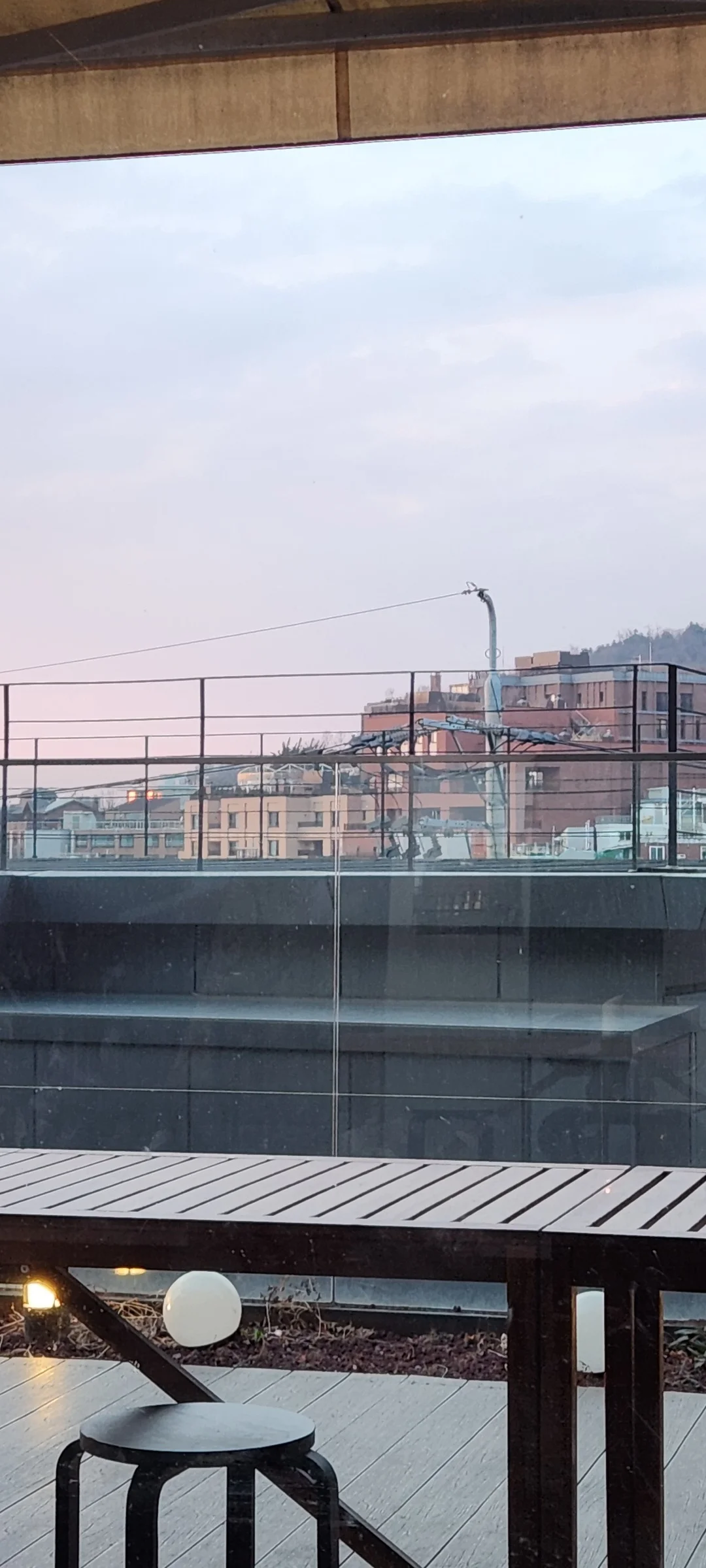 Wrap your phone in the cozy, Instagram-worthy atmosphere of Korean cafe culture. Korea's cafes are more than coffee shops — they're design experiences. These wallpapers feature warm interior light falling on minimalist wooden counters, perfectly crafted latte art in handmade ceramic cups, floor-to-ceiling windows overlooking quiet streets, and rooftop terraces with city panoramas.

From industrial-chic converted warehouses in Seongsu to tiny hidden basement cafes in Ikseon-dong, each image captures the aesthetic sensibility that makes Korean cafe design world-famous. Trailing plants, warm Edison bulbs, curated book walls, and the soft golden glow of afternoon light create scenes you'll want to stare at. Download these free Korean cafe wallpapers for a phone background that feels like a warm hug., Hoenamu-ro, Itaewon 2(i)-dong, Seoul — Free Korean aesthetic wallpaper