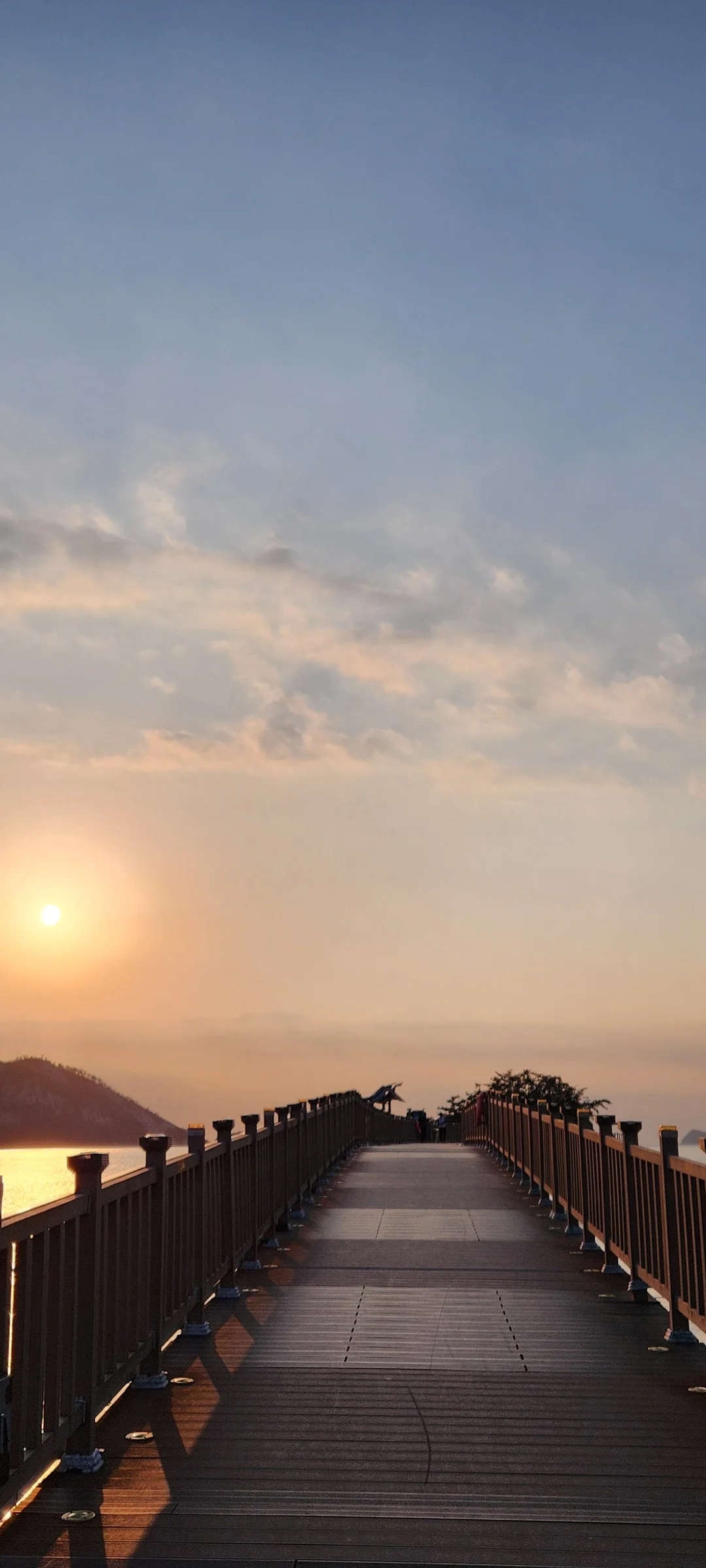 Bring the Korean coastline to your phone with these breathtaking ocean wallpapers. Korea is surrounded by water on three sides, and this collection captures it all — the turquoise shallows of Jeju's beaches, dramatic basalt cliffs plunging into the East Sea, tranquil fishing harbors at dawn, and endless Pacific horizons glowing under golden light.

These photos feature crashing waves against volcanic rock formations, serene island silhouettes at sunset, lighthouse beacons cutting through coastal fog, and the mirror-still surface of sheltered bays reflecting cotton-candy skies. Download these free Korean sea wallpapers for an aesthetic phone background that carries the calm and power of the ocean wherever you go., Seonyudo 1-gil, Gunsan-si — Free Korean aesthetic wallpaper