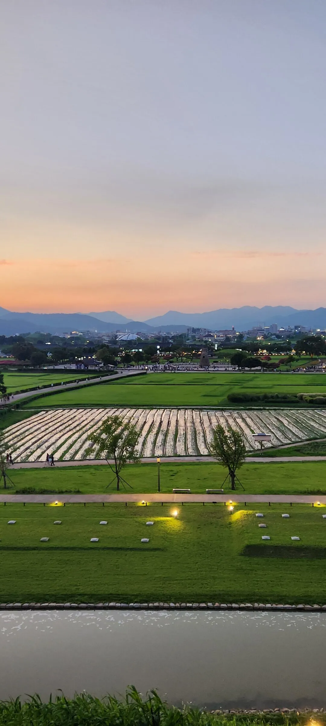 Transform your phone with the inviting green spaces of Korea's parks and gardens. From the sprawling lawns of Olympic Park in Seoul to the meticulously landscaped botanical gardens of the southern coast, these wallpapers capture the beauty of Korea's curated natural spaces — blooming flower beds, reflective lotus ponds, tree-lined promenades, and autumn foliage canopies.

Korean parks are designed for contemplation, and it shows in every image: stone pathways curving around still water, wooden pavilions framed by seasonal color, cherry-blossom tunnels creating pink corridors, and wide meadows where families gather under open skies. Free download these aesthetic park wallpapers and give your phone background the refreshing energy of a Korean garden escape., Inwang-dong, Wolseong-dong, Gyeongju-si — Free Korean aesthetic wallpaper