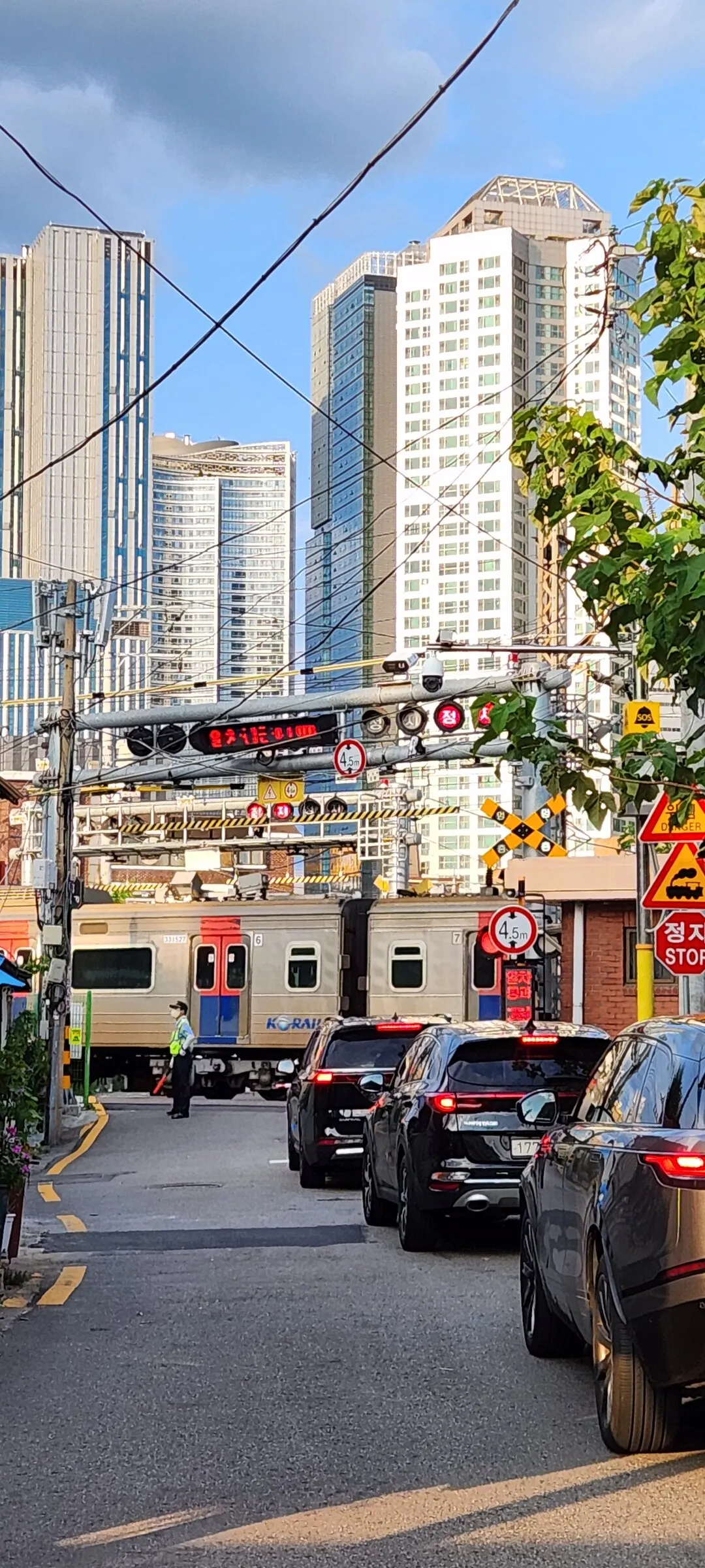 Experience the vibrant pulse of Korean city life through these dynamic street wallpapers. Bustling crosswalks in Myeongdong, colorful shop fronts in Hongdae, rain-slicked sidewalks reflecting neon signs, and everyday moments of commuters, street vendors, and cyclists moving through Seoul's urban rhythm — each image tells a story of a city constantly in motion.

Beyond Seoul, you'll find the charming streetscapes of Busan's hillside neighborhoods, the retro storefronts of Jeonju, and quiet residential lanes where laundry dries on balconies above parked scooters. These free Korean street wallpapers are perfect as an aesthetic phone background for anyone captivated by the raw energy and visual richness of Korean urban culture., Ichon-ro 29-gil, Hangangno-dong, Seoul — Free Korean aesthetic wallpaper