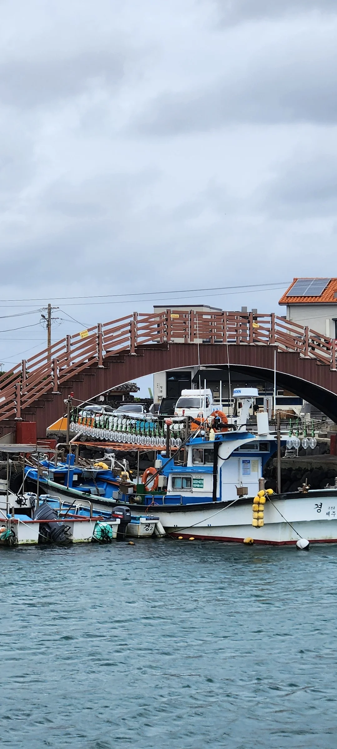 Bring the Korean coastline to your phone with these breathtaking ocean wallpapers. Korea is surrounded by water on three sides, and this collection captures it all — the turquoise shallows of Jeju's beaches, dramatic basalt cliffs plunging into the East Sea, tranquil fishing harbors at dawn, and endless Pacific horizons glowing under golden light.

These photos feature crashing waves against volcanic rock formations, serene island silhouettes at sunset, lighthouse beacons cutting through coastal fog, and the mirror-still surface of sheltered bays reflecting cotton-candy skies. Download these free Korean sea wallpapers for an aesthetic phone background that carries the calm and power of the ocean wherever you go., Bukchon 11-gil, Jeju — Free Korean aesthetic wallpaper