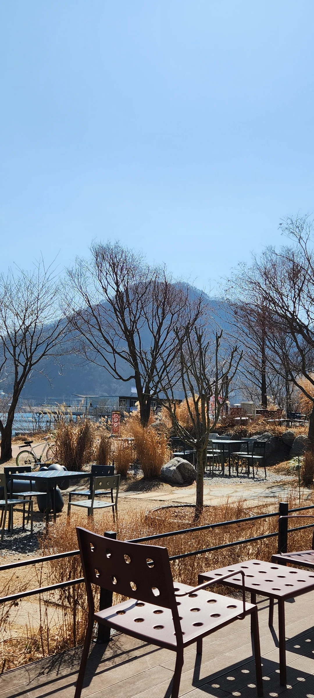 Wrap your phone in the cozy, Instagram-worthy atmosphere of Korean cafe culture. Korea's cafes are more than coffee shops — they're design experiences. These wallpapers feature warm interior light falling on minimalist wooden counters, perfectly crafted latte art in handmade ceramic cups, floor-to-ceiling windows overlooking quiet streets, and rooftop terraces with city panoramas.

From industrial-chic converted warehouses in Seongsu to tiny hidden basement cafes in Ikseon-dong, each image captures the aesthetic sensibility that makes Korean cafe design world-famous. Trailing plants, warm Edison bulbs, curated book walls, and the soft golden glow of afternoon light create scenes you'll want to stare at. Download these free Korean cafe wallpapers for a phone background that feels like a warm hug., Bukhangang-ro, Namyangju-si — Free Korean aesthetic wallpaper